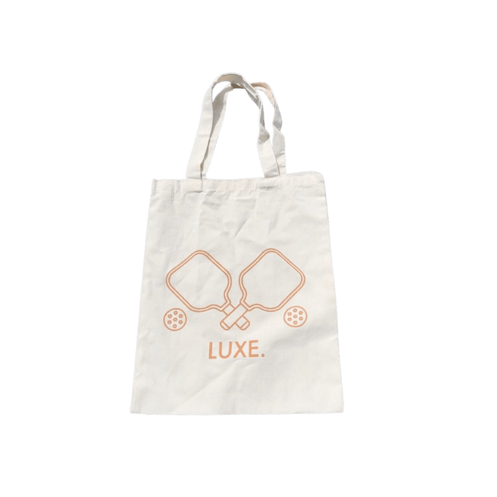 Off-white tote bag with brown pickleball paddle and ball design.
