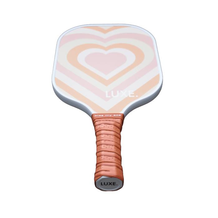 Pickleball paddle with heart design and wrapped handle.