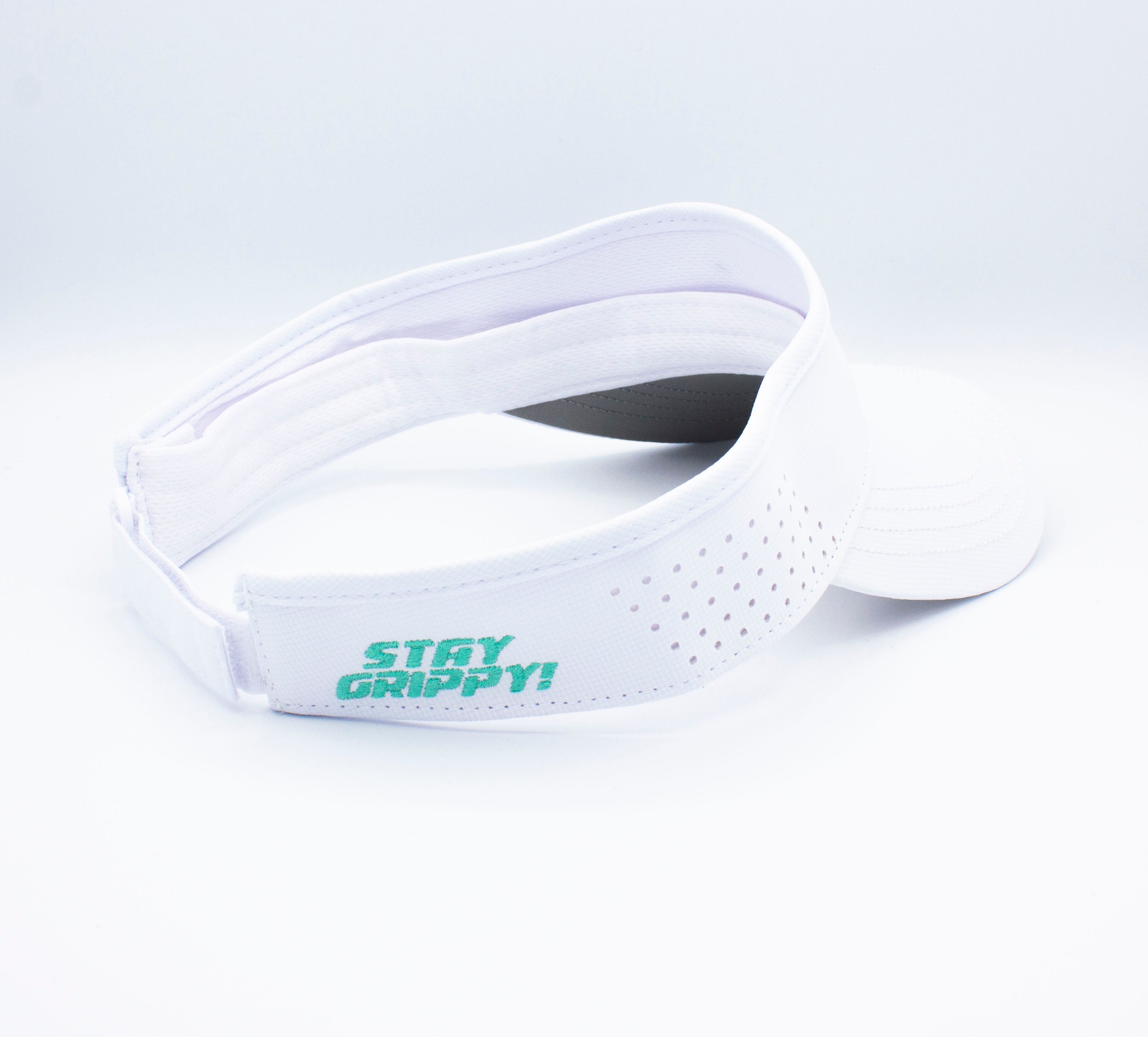 White sun visor with green lettering.
