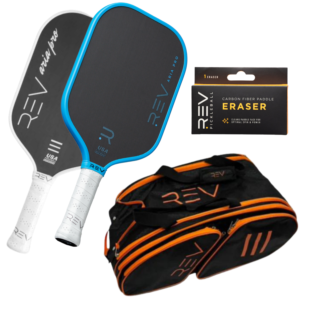 Professional pickleball paddle bundle with black and blue Aria Pro paddles by REV, orange-accented carrying bag, and carbon fiber paddle eraser, flat lay view