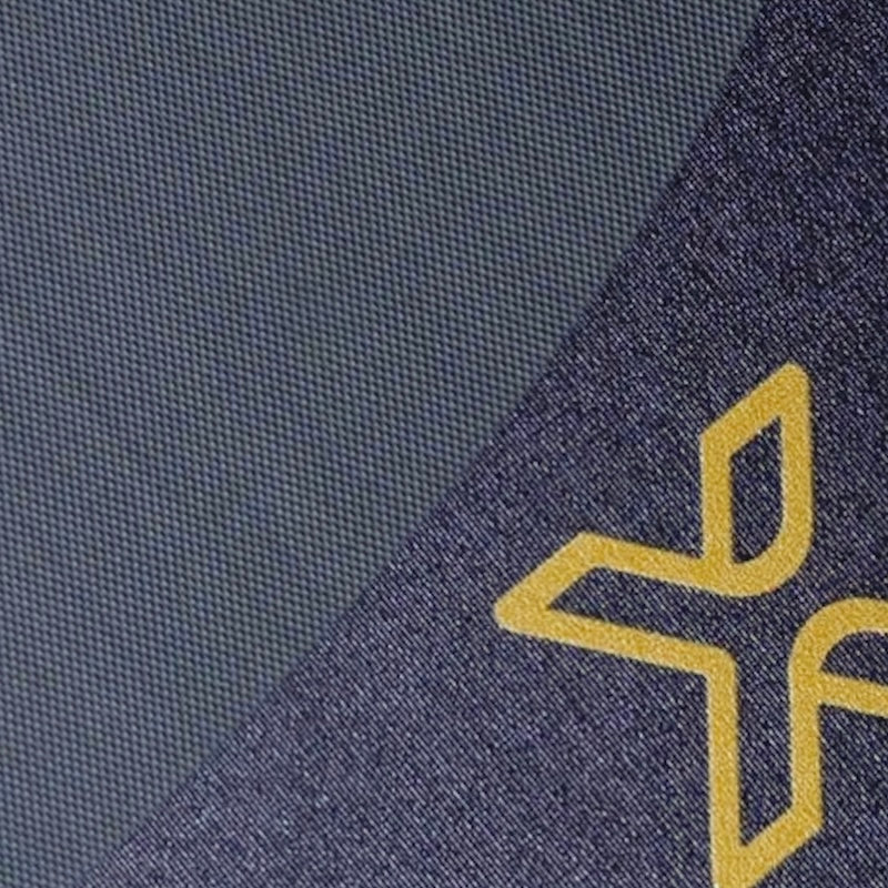 Close-up of navy fabric with a yellow logo.
