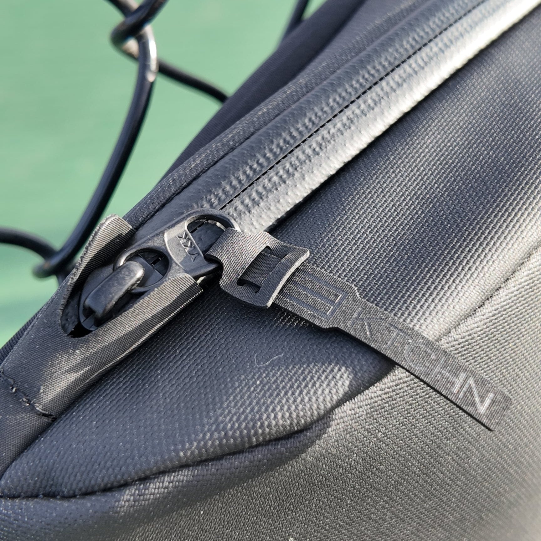 Close-up of black fabric bag with zipper.