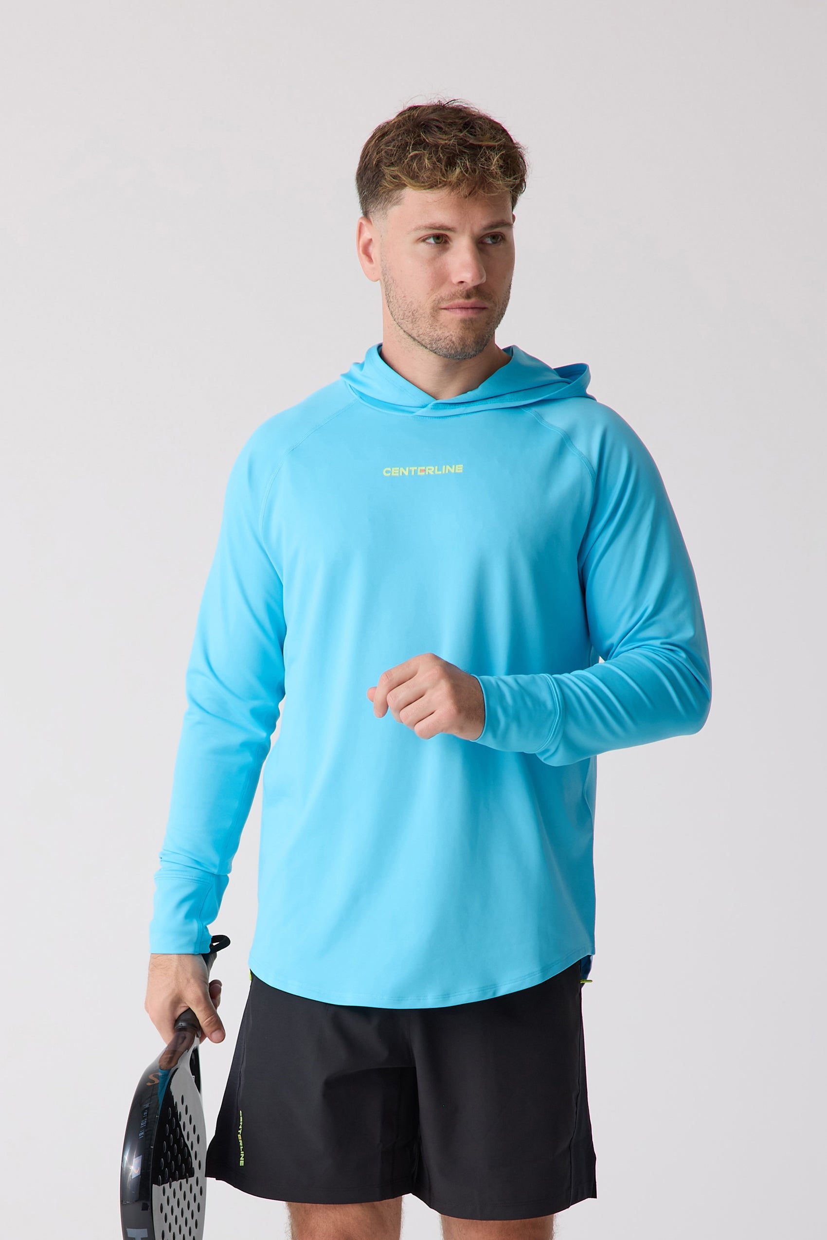 Light blue men's layering hoodie by Centerline Athletics with "CENTERLINE" logo, worn by a man holding a paddle.