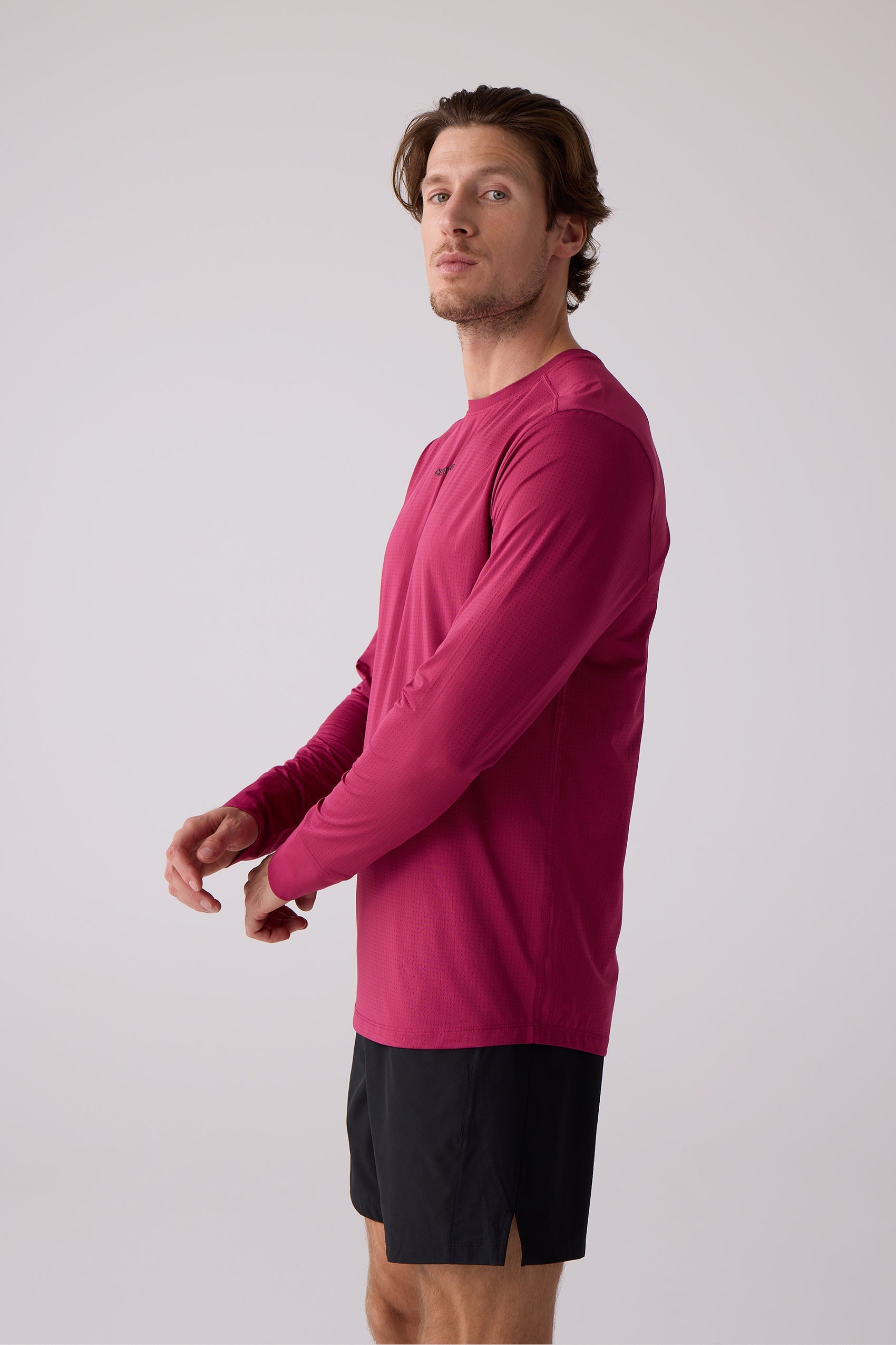 Men's deep magenta AirLite long sleeve shirt by Centerline Athletics, featuring a perforated texture, worn by a man.