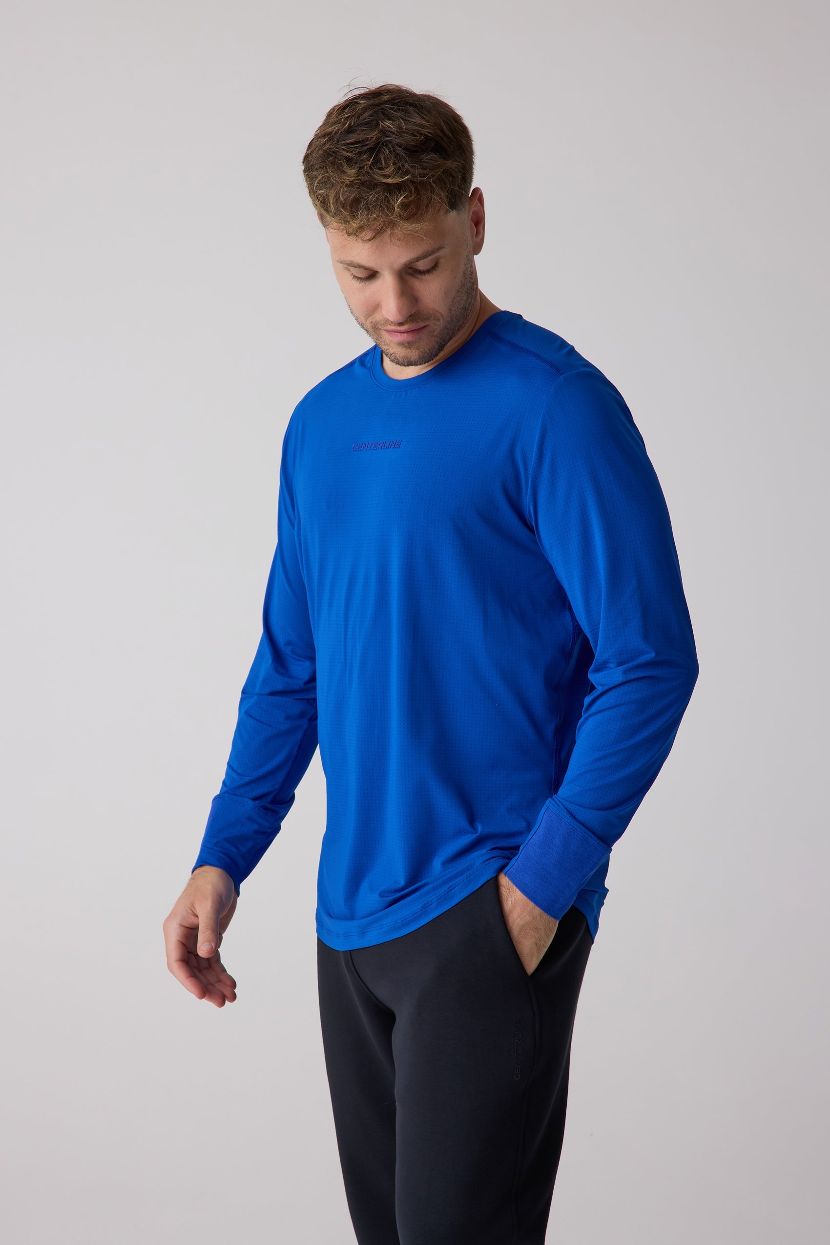 Men's bright blue AirLite Long Sleeve by Centerline Athletics, with a subtle grid texture and embossed brand name.