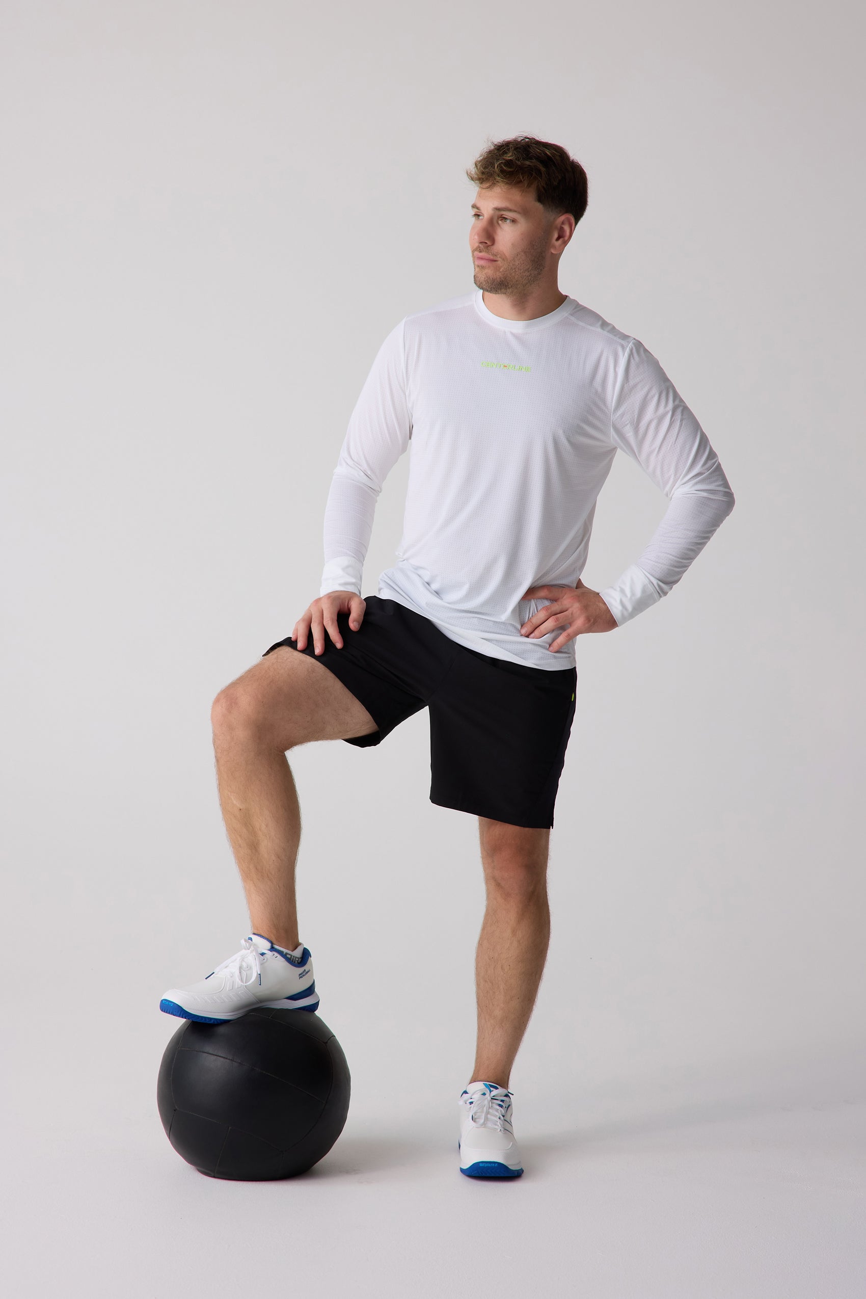 White men's long sleeve shirt by Centerline Athletics featuring a subtle mesh pattern, modeled with black shorts.