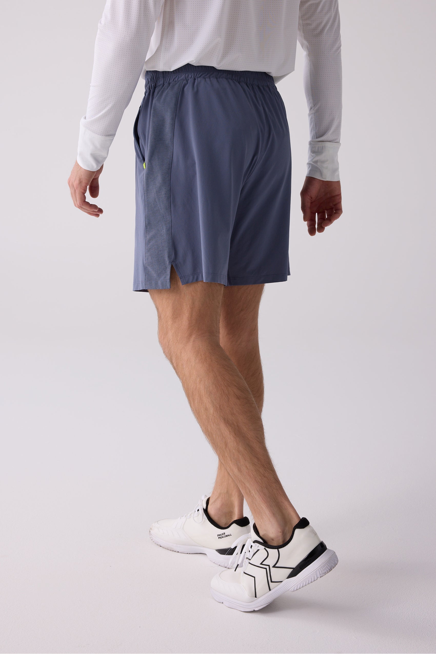 Blue men's short by Centerline Athletics, back view, with elastic waist, side vents, and neon yellow zipper detail.