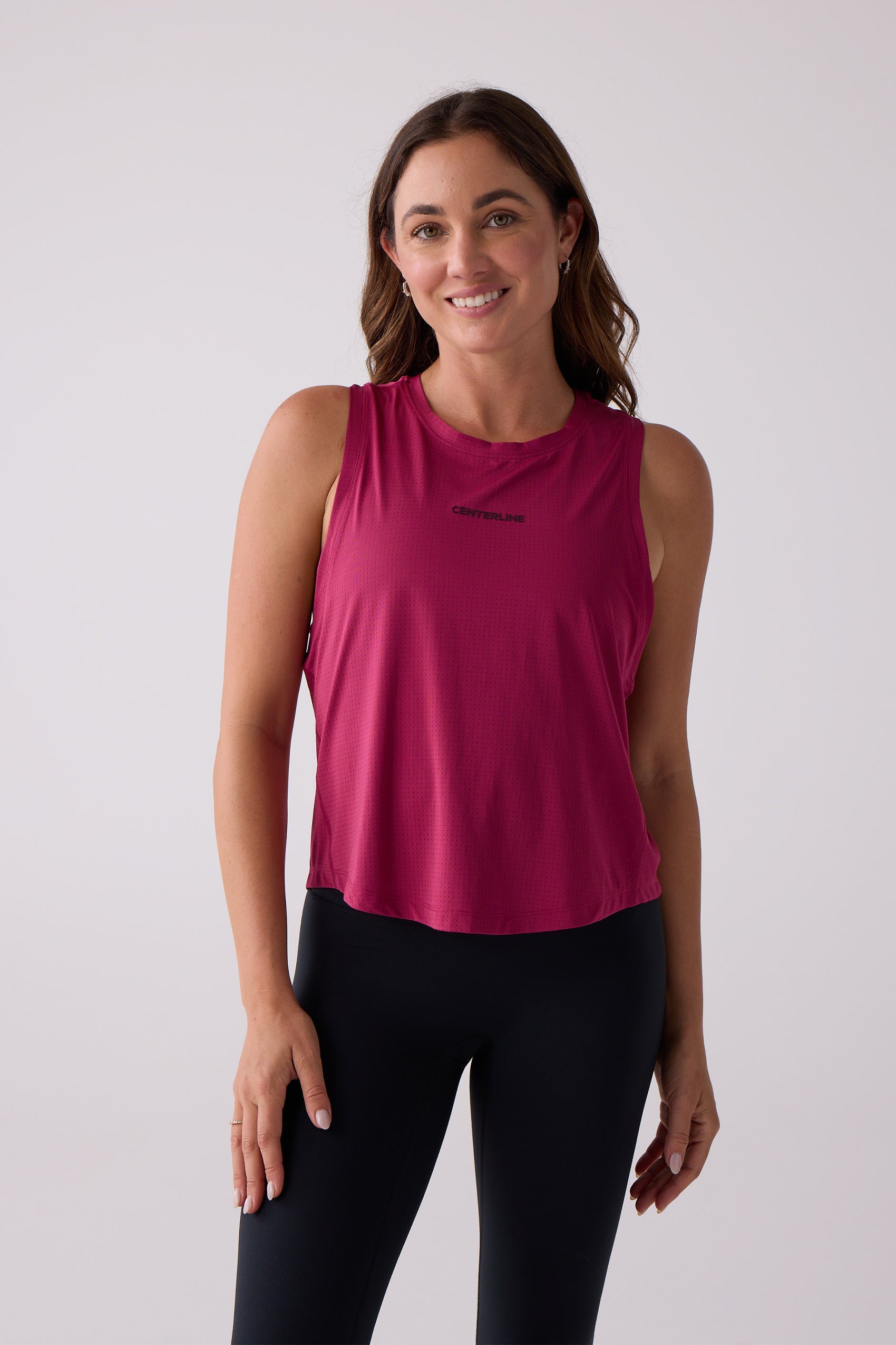 Women's magenta perforated tank top by Centerline Athletics with "CENTERLINE" text on the chest.