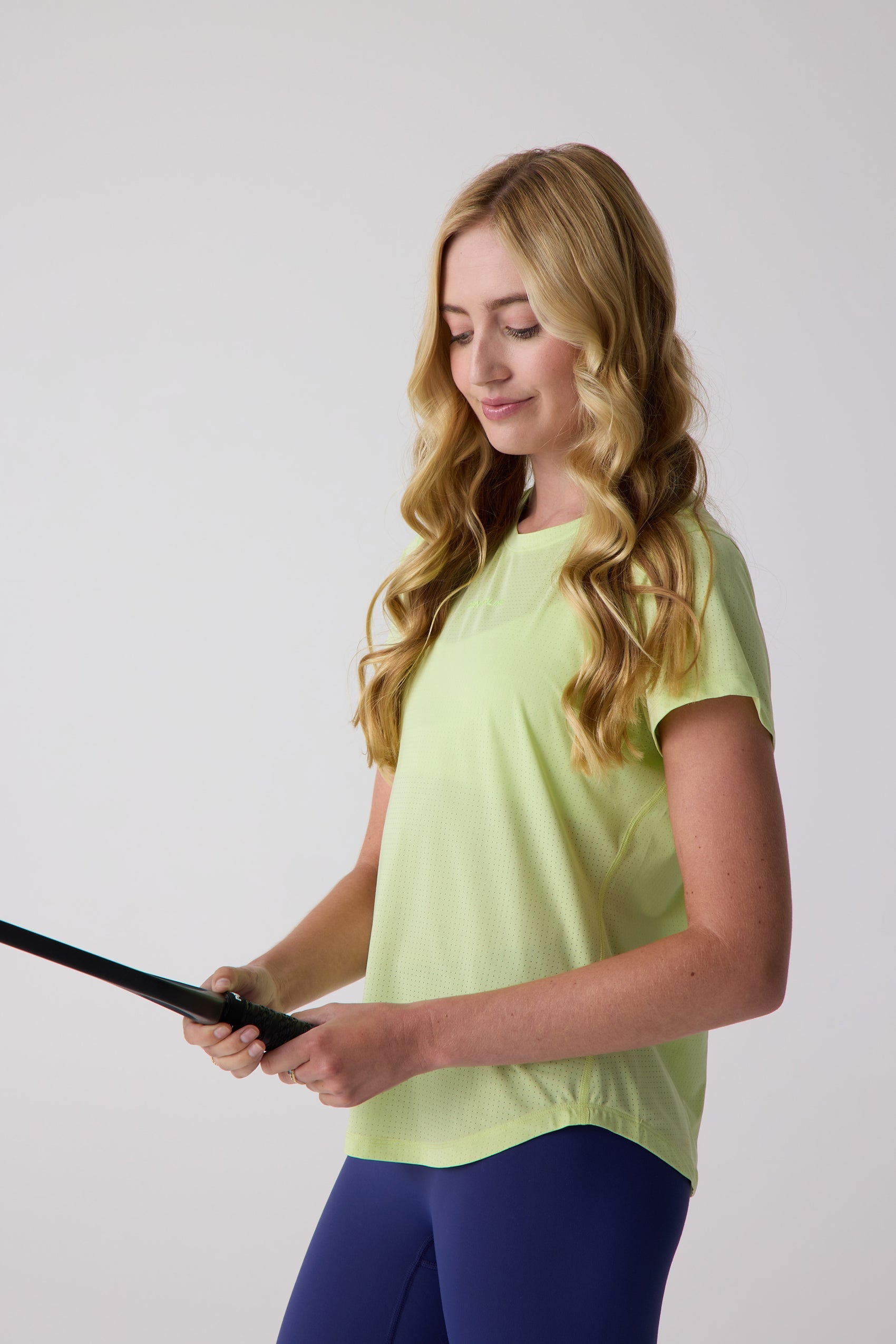 Neon green Women's AirLite Tee by Centerline Athletics, featuring a perforated lightweight fabric.