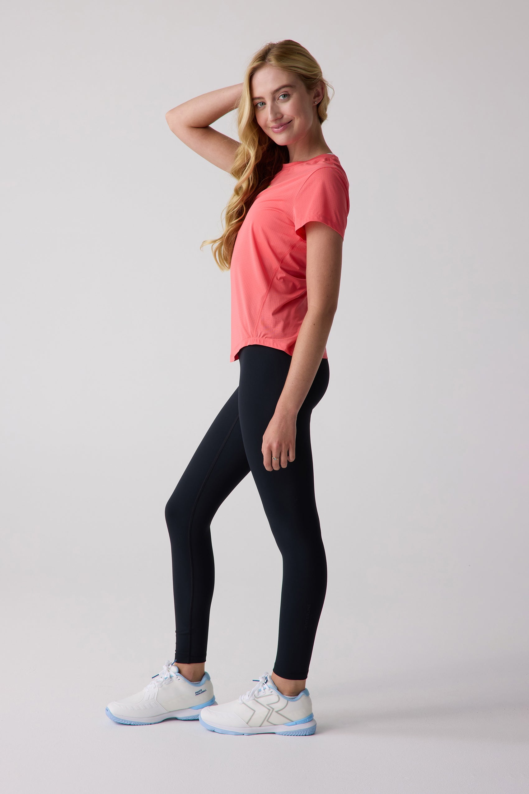 Coral short sleeve tee by Centerline Athletics, with a perforated texture, worn by a model.