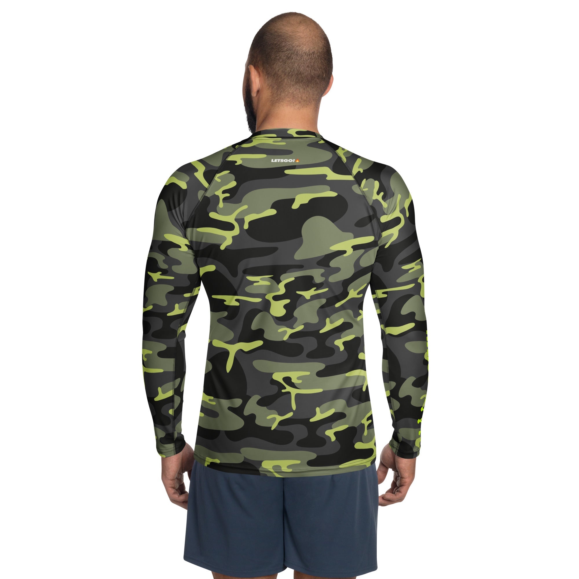 Man wearing a camo rash guard and blue shorts from the back.