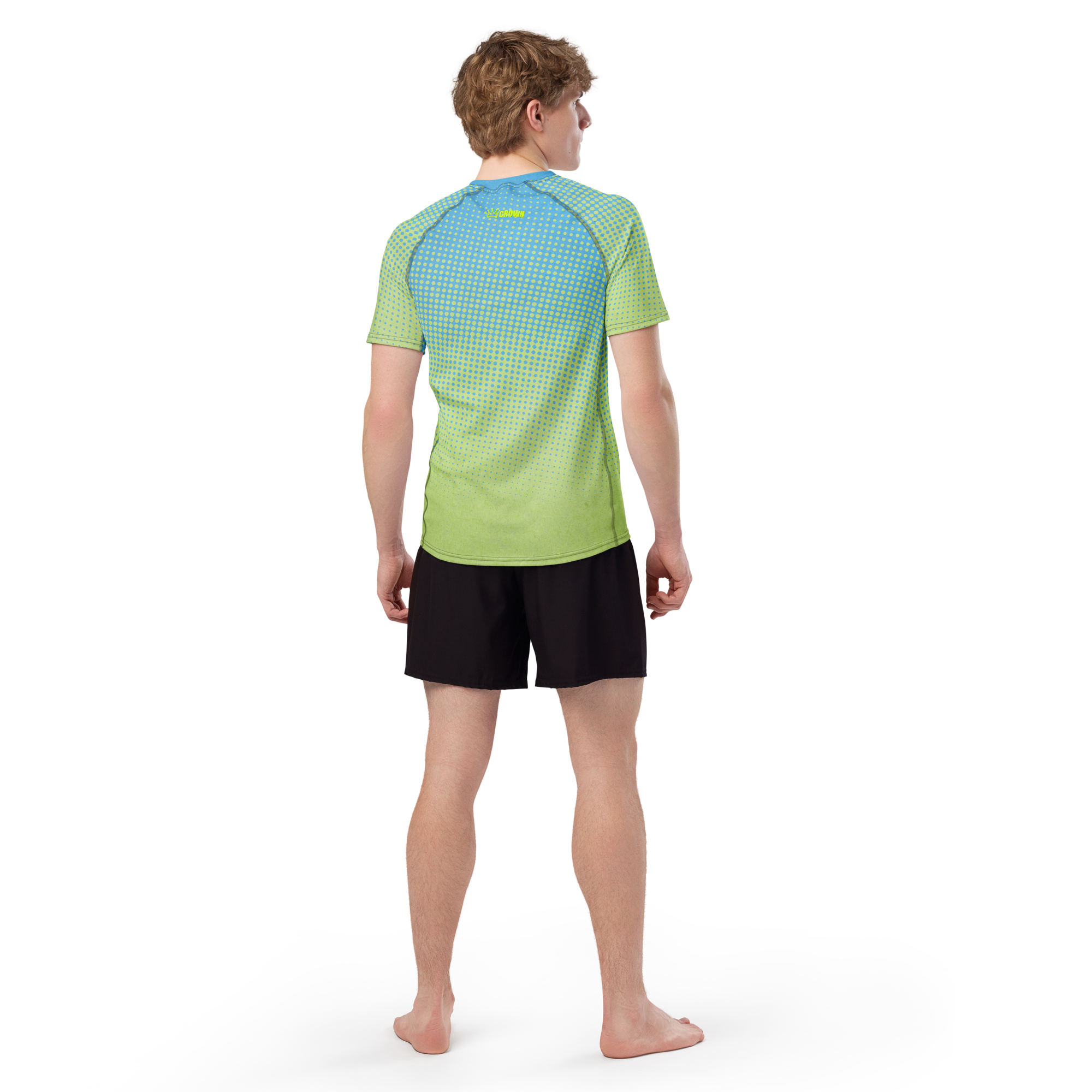 Man wearing a gradient green and blue polka dot shirt and black shorts.