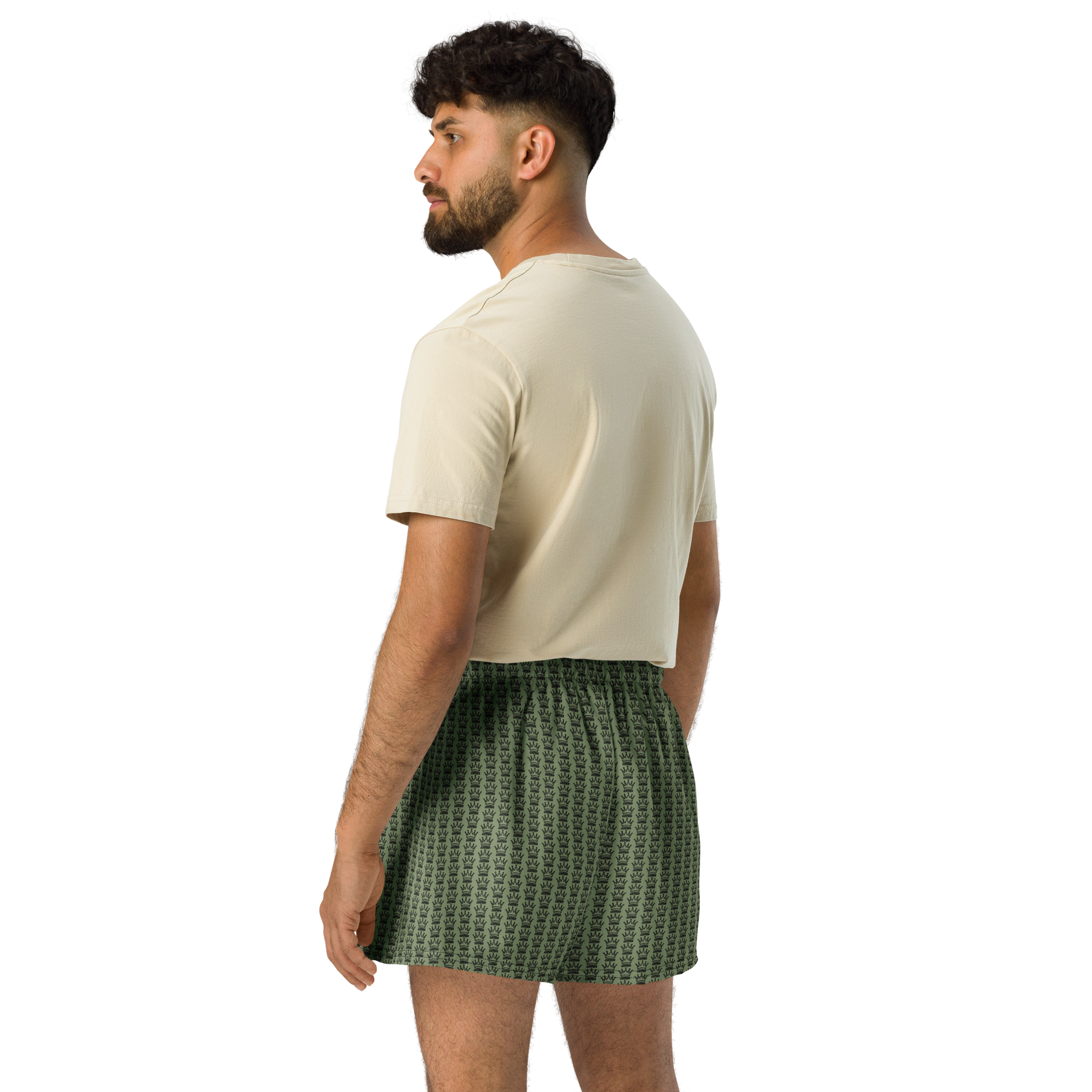 Man with a beard in a t-shirt and green crown-print boxer shorts.