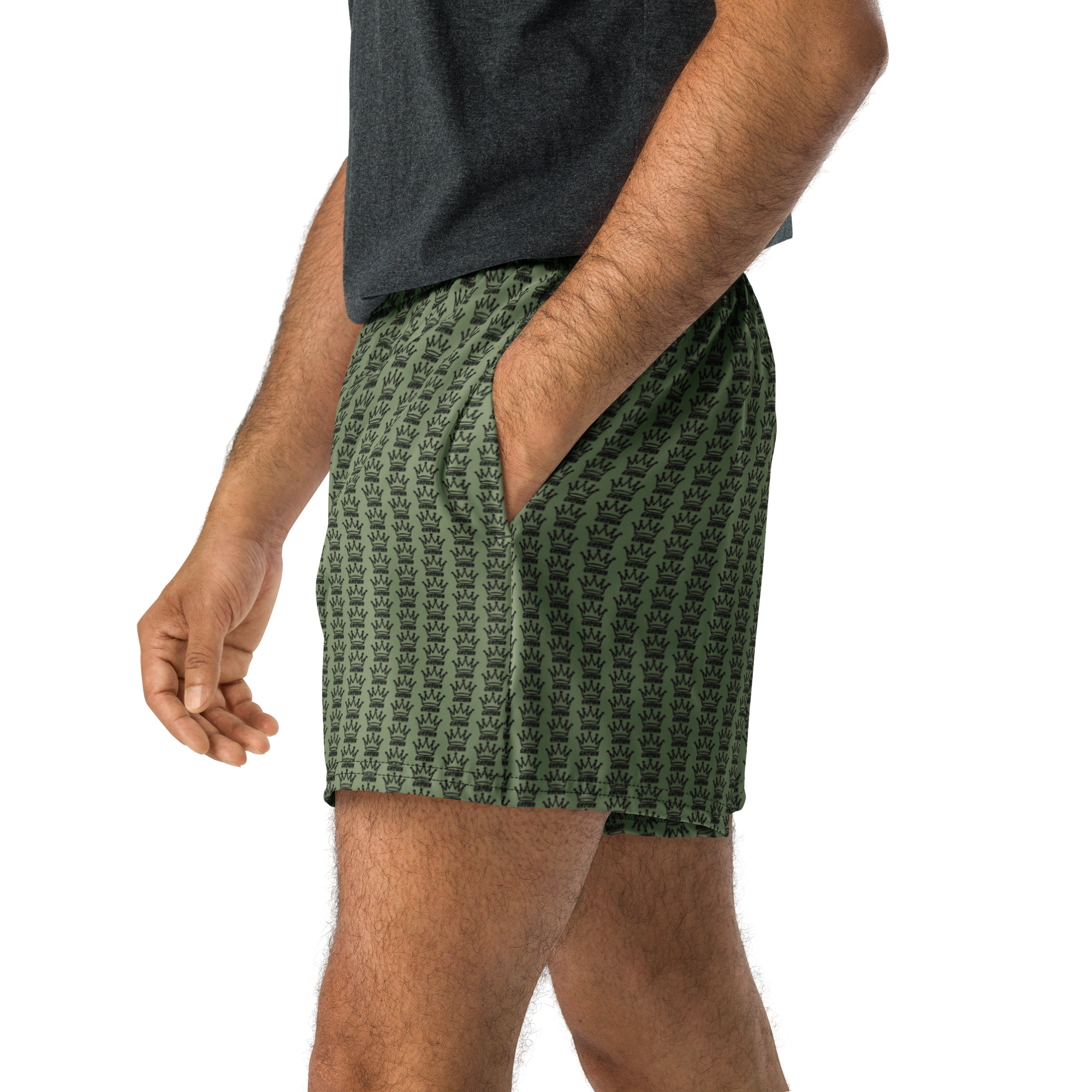 A person wearing green shorts with a black crown pattern and a gray t-shirt.