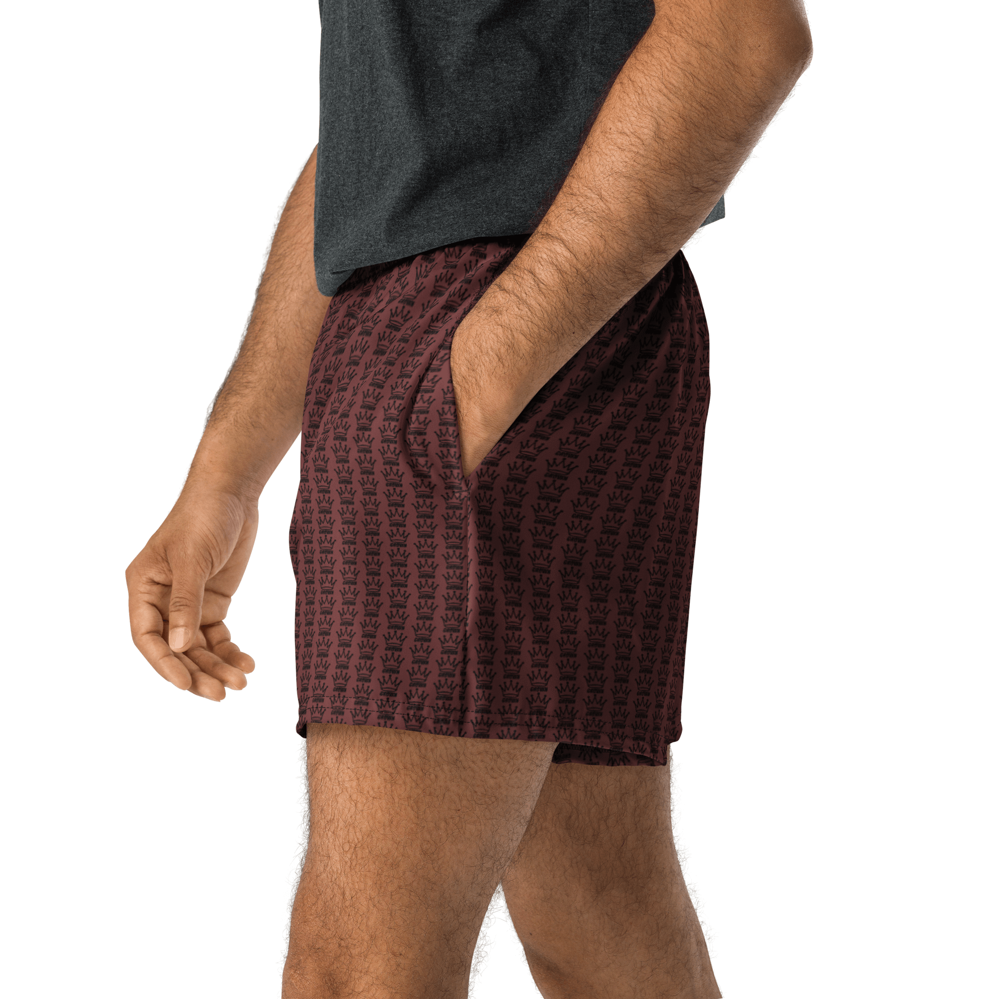 A man in patterned maroon shorts with his hand in his pocket.