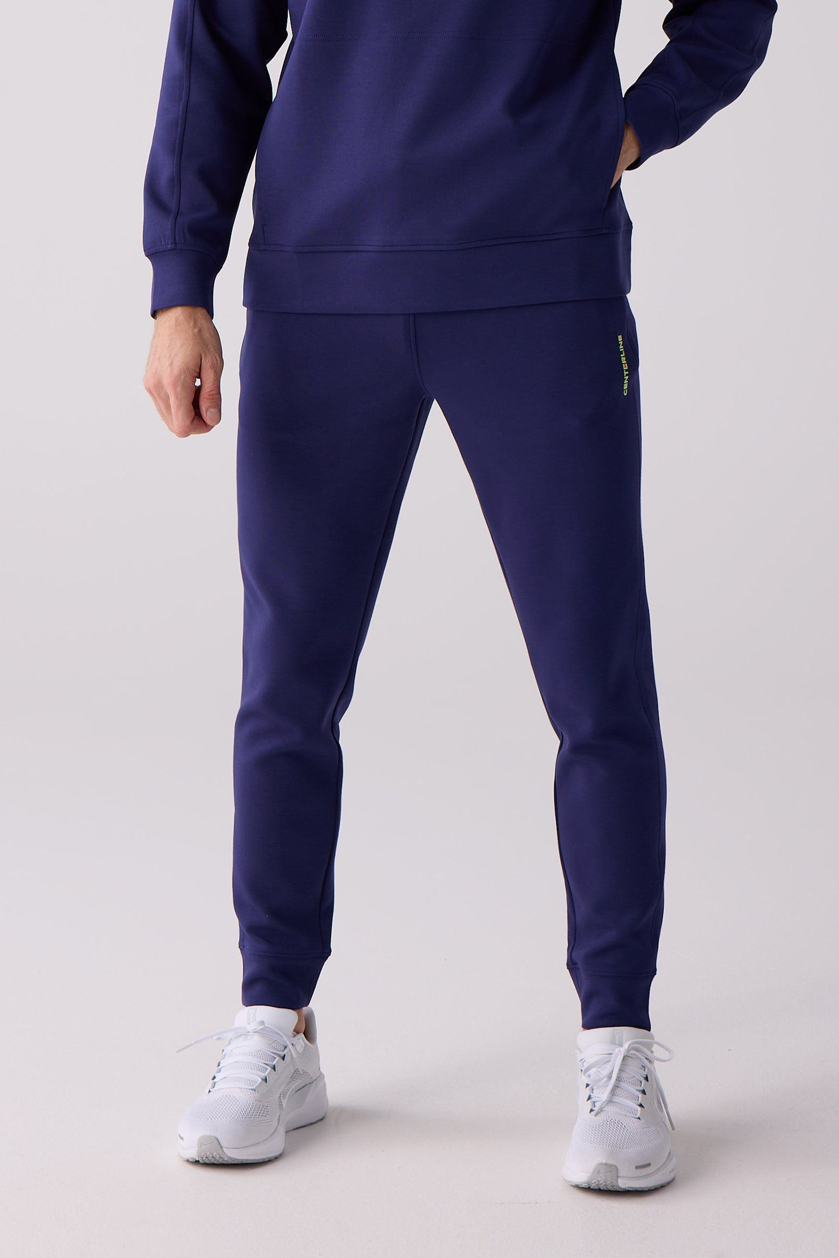 Men's navy blue jogger pants by Centerline Athletics, featuring a bright green vertical logo on the left leg.