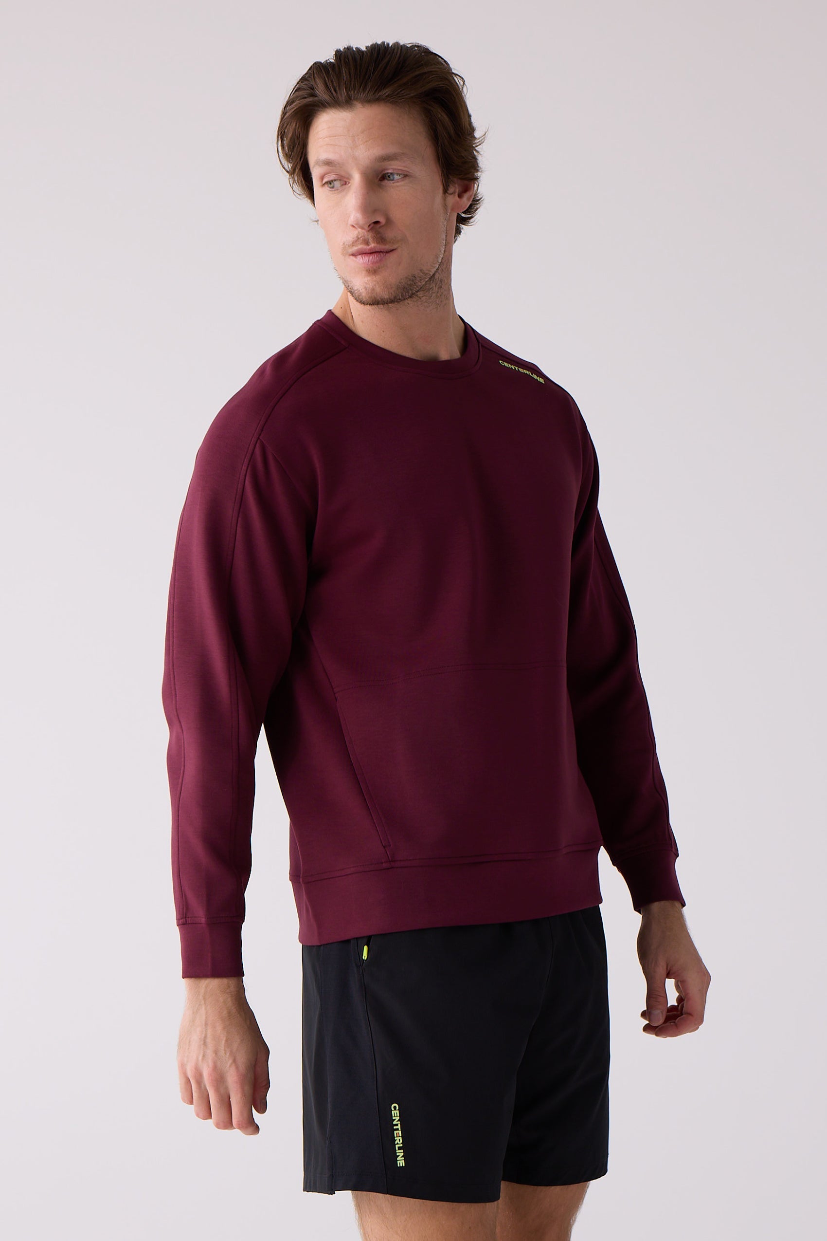 Maroon Men's Crew Sweatshirt by Centerline Athletics, with lime logo on shoulder, worn with black shorts.