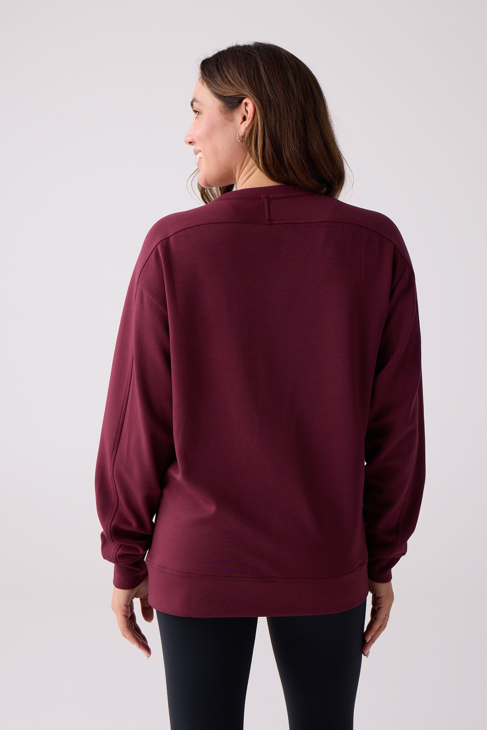 Maroon crew sweatshirt by Centerline Athletics, back view with ribbed cuffs and hem, worn by a woman.