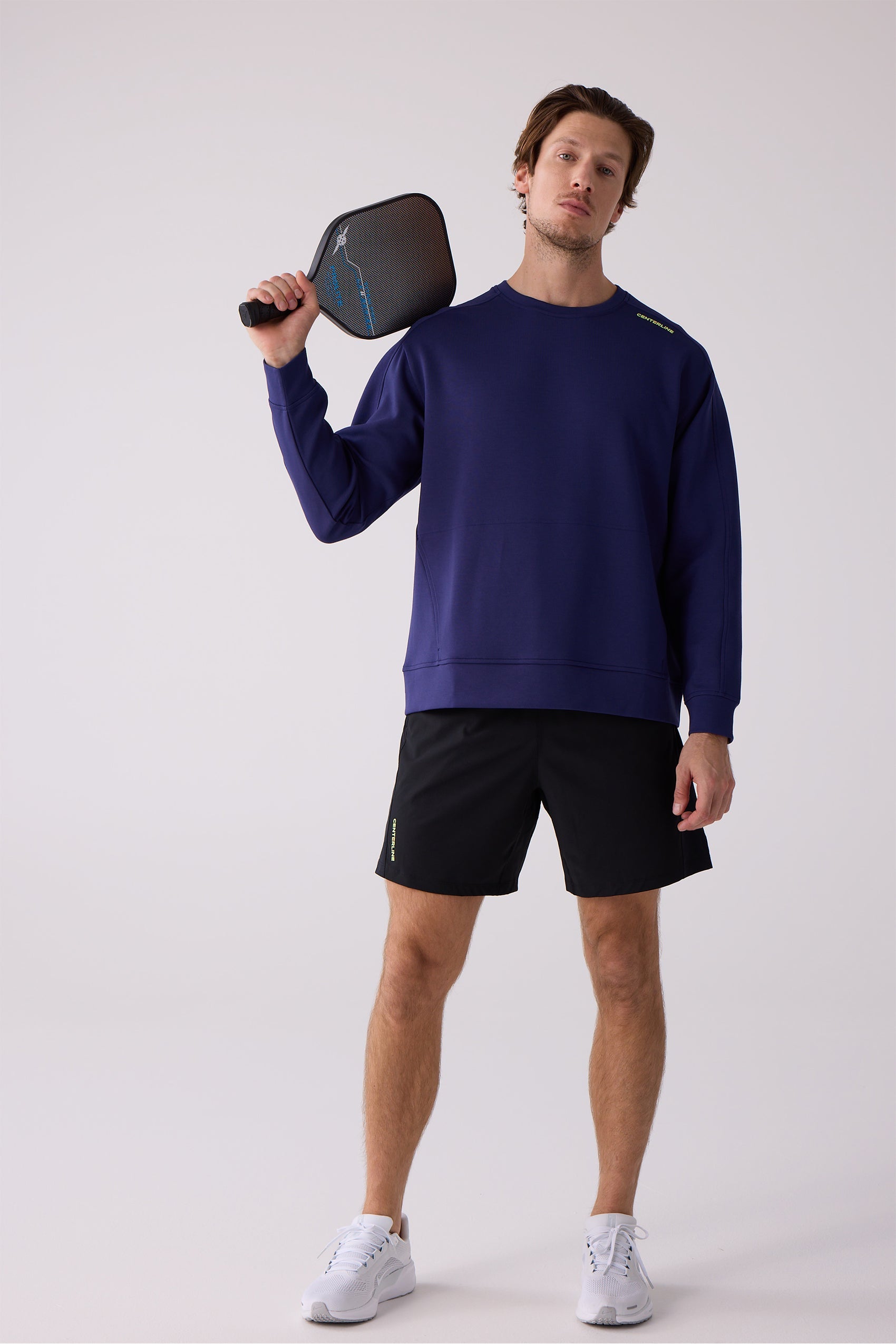 Navy blue men's crew sweatshirt by Centerline Athletics with yellow 'CENTERLINE' text on the shoulder, worn with black shorts.