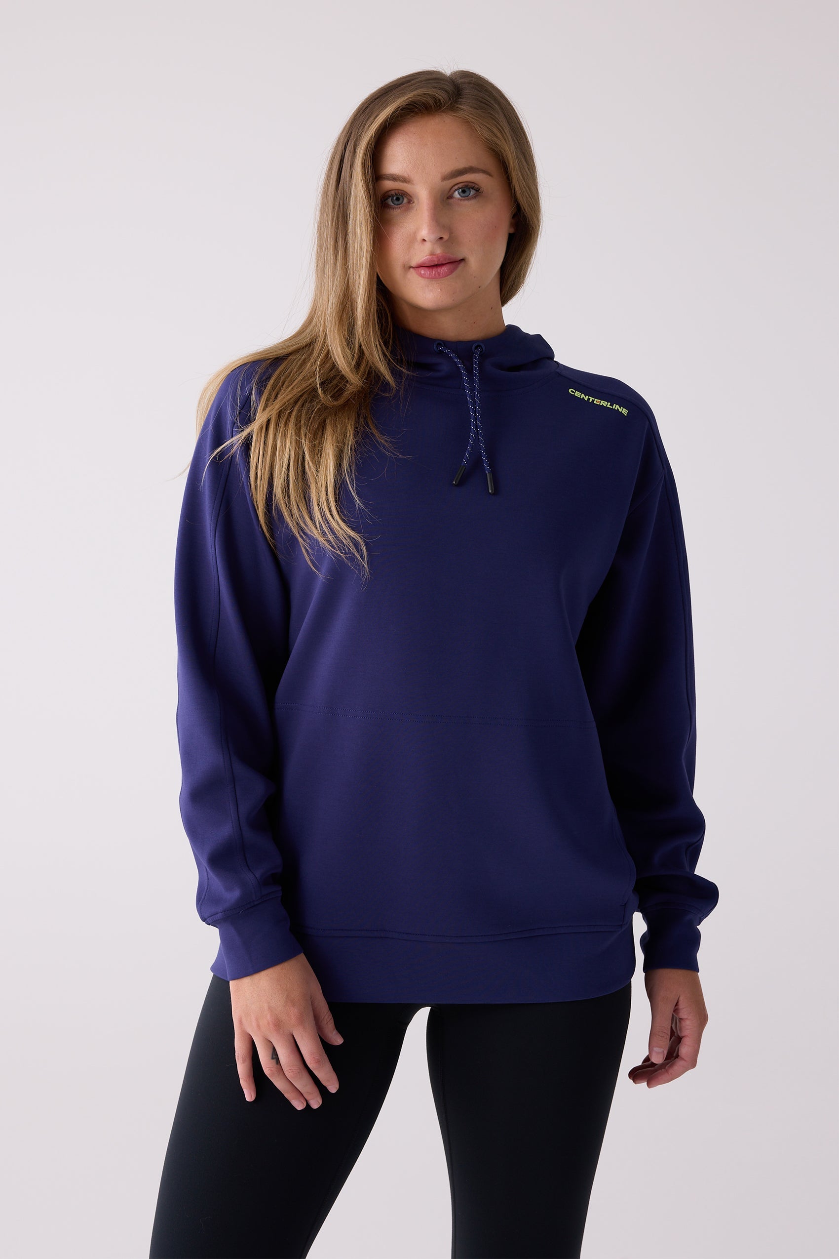 Navy blue hooded sweatshirt by Centerline Athletics, with lime green 'CENTERLINE' text on shoulder and a drawstring, worn with black leggings.