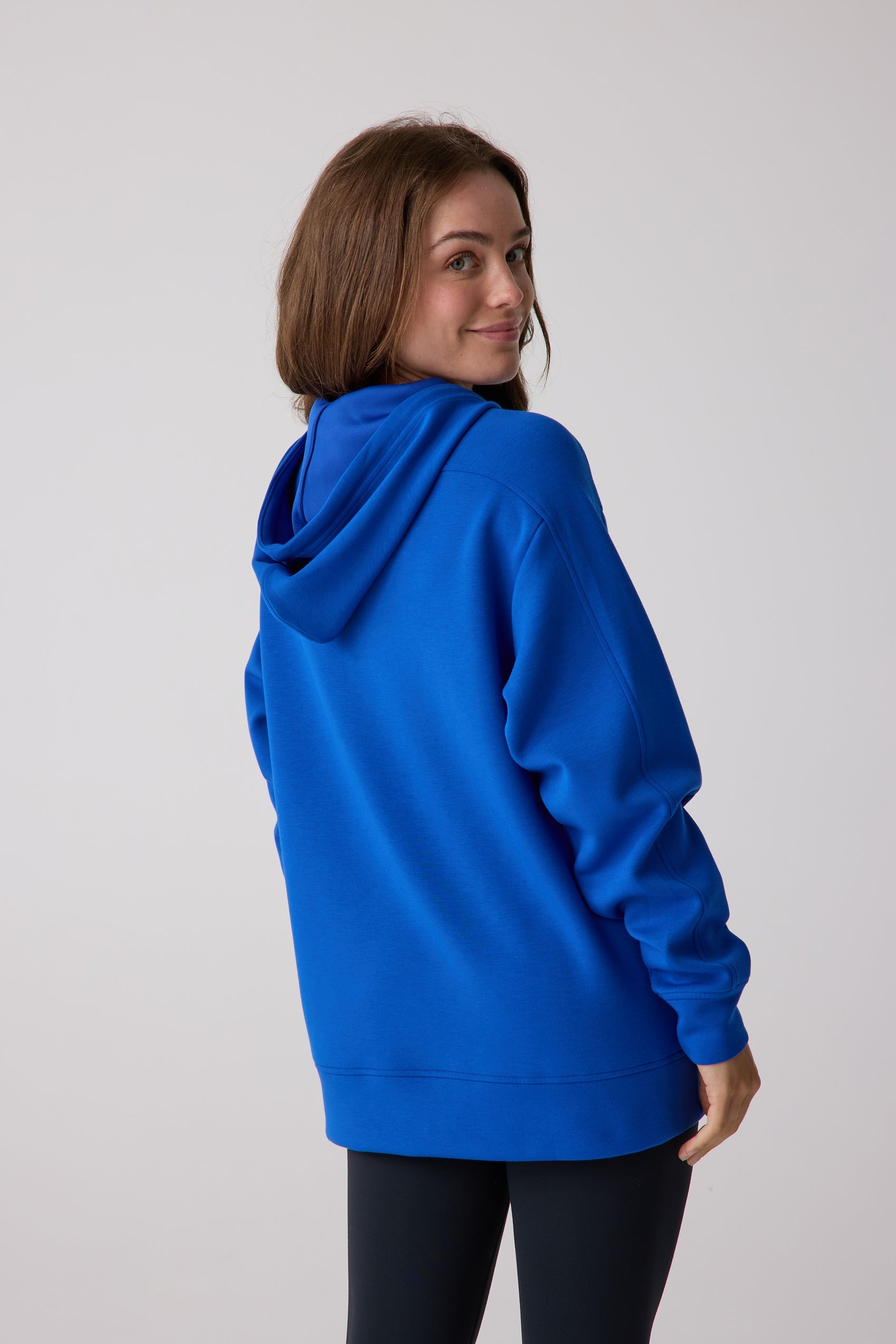 Royal blue oversized hooded sweatshirt by Centerline Athletics, with ribbed cuffs and hem, shown from a back-side view.