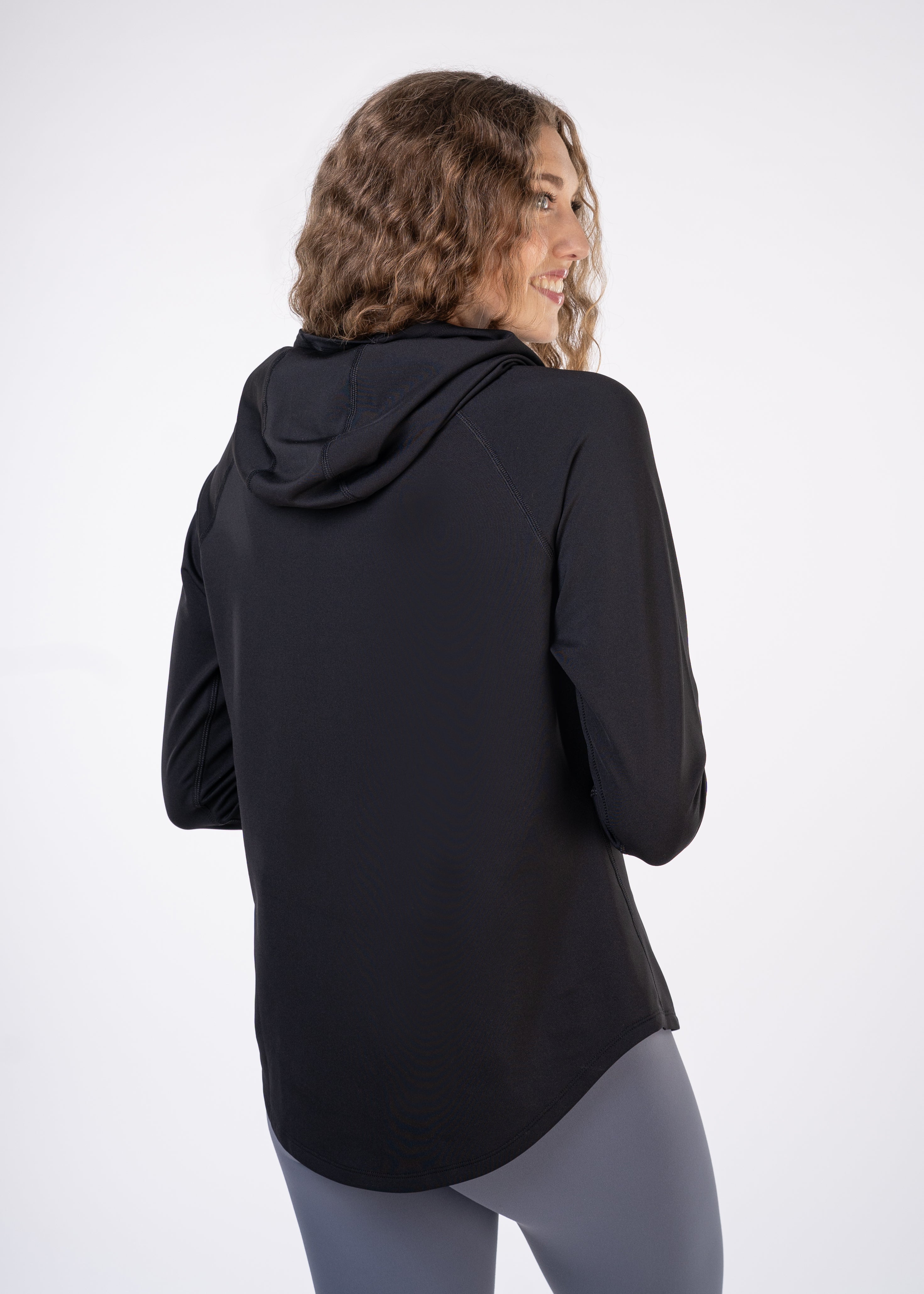 Woman in black hoodie and grey leggings.