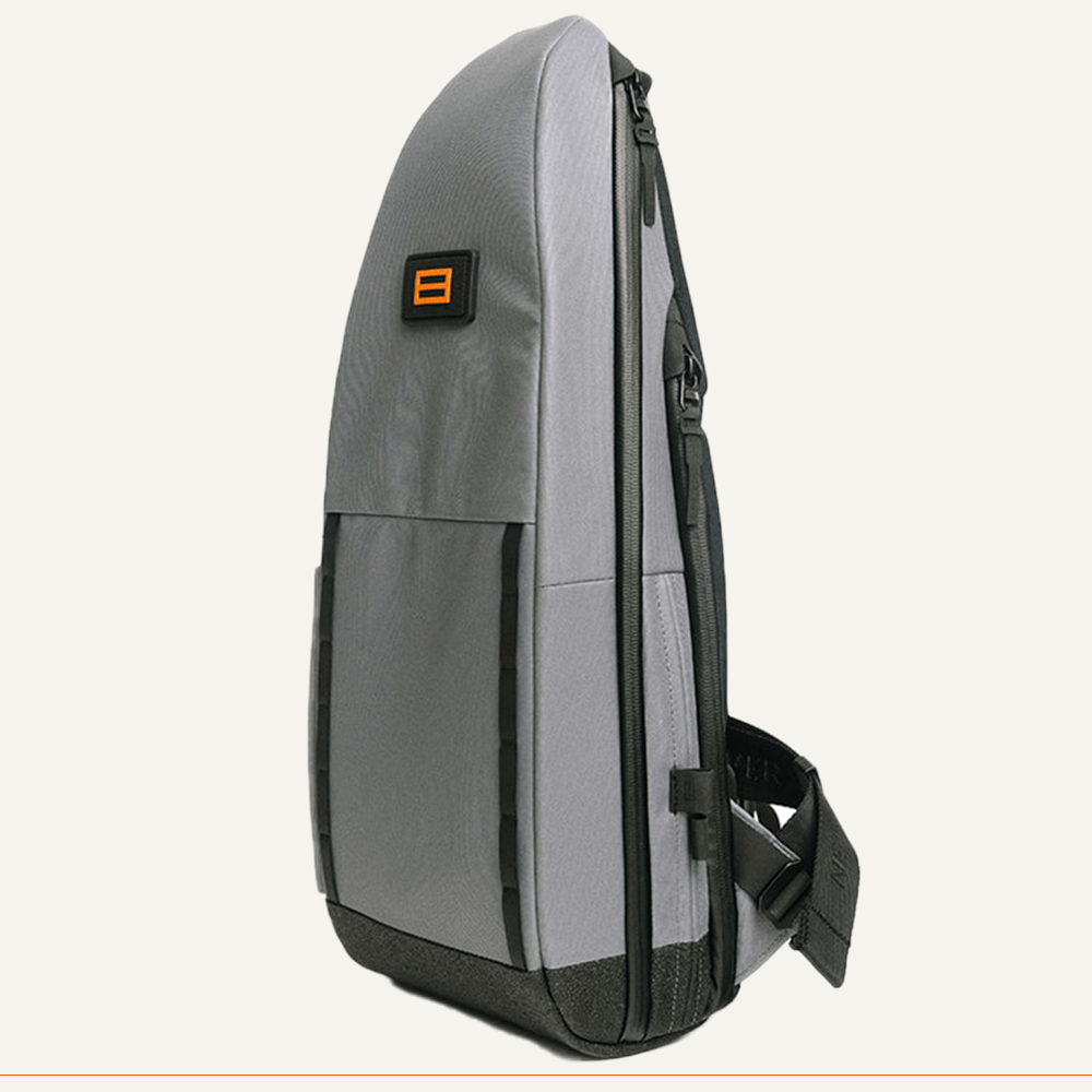 Gray cross-body bag with orange logo.