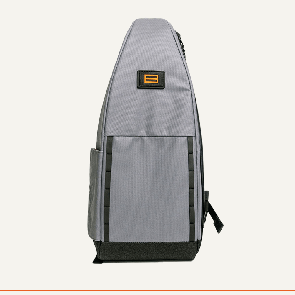 Gray shoulder bag with black accents and orange logo patch.