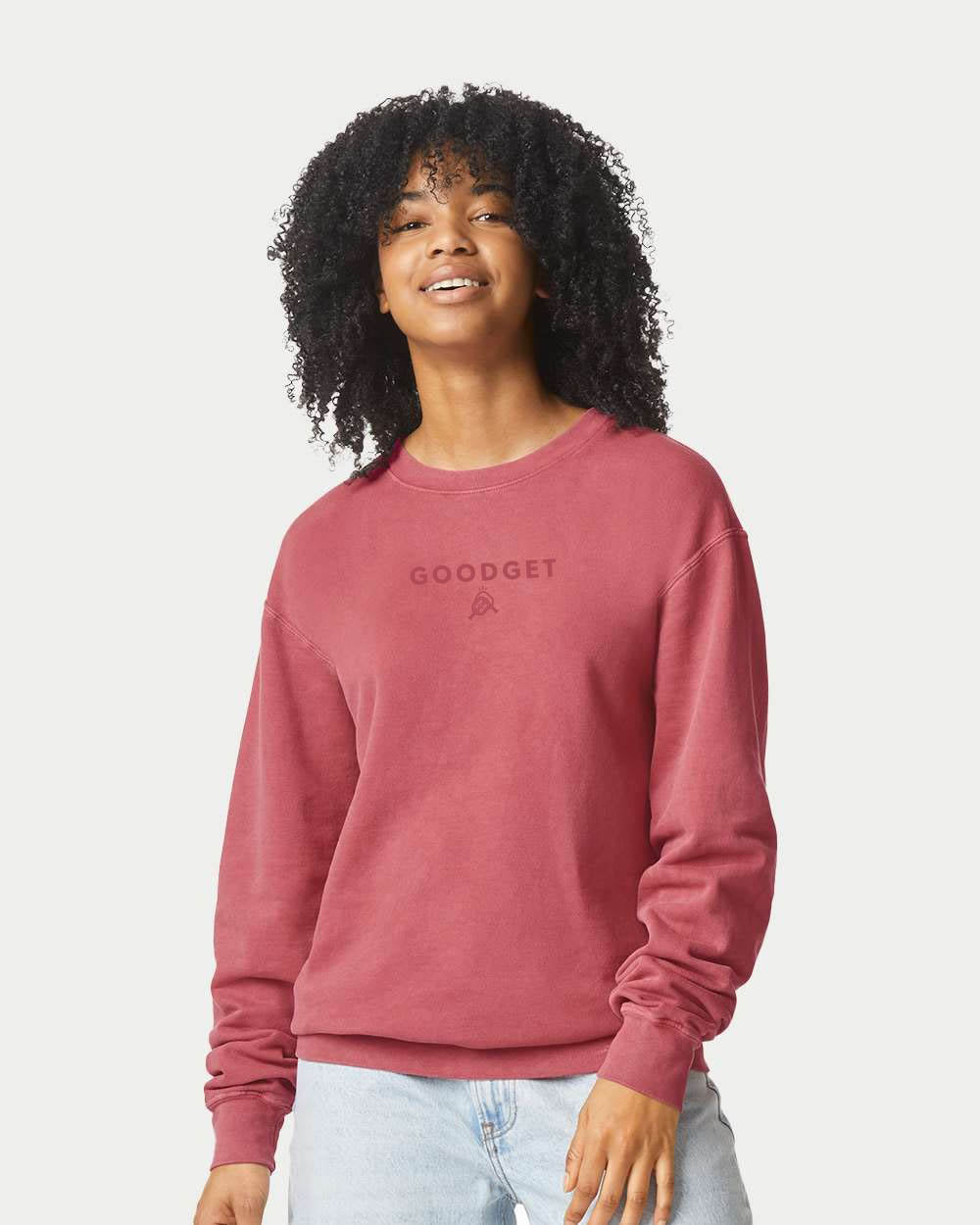 Dusty red crewneck sweatshirt by Good Get featuring tone-on-tone "GOODGET" text and logo on the chest.