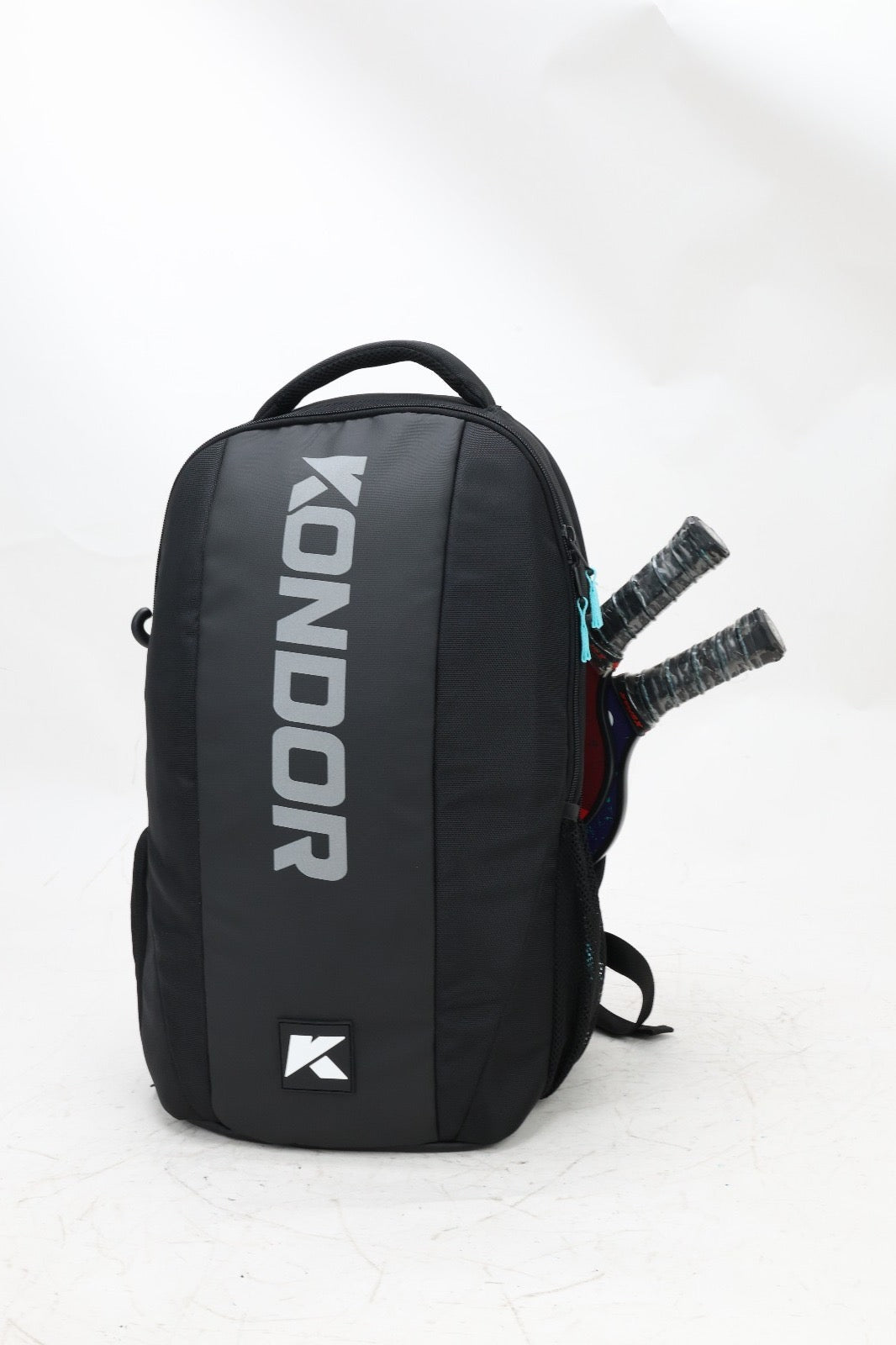 Black backpack with tennis rackets in a side pocket.