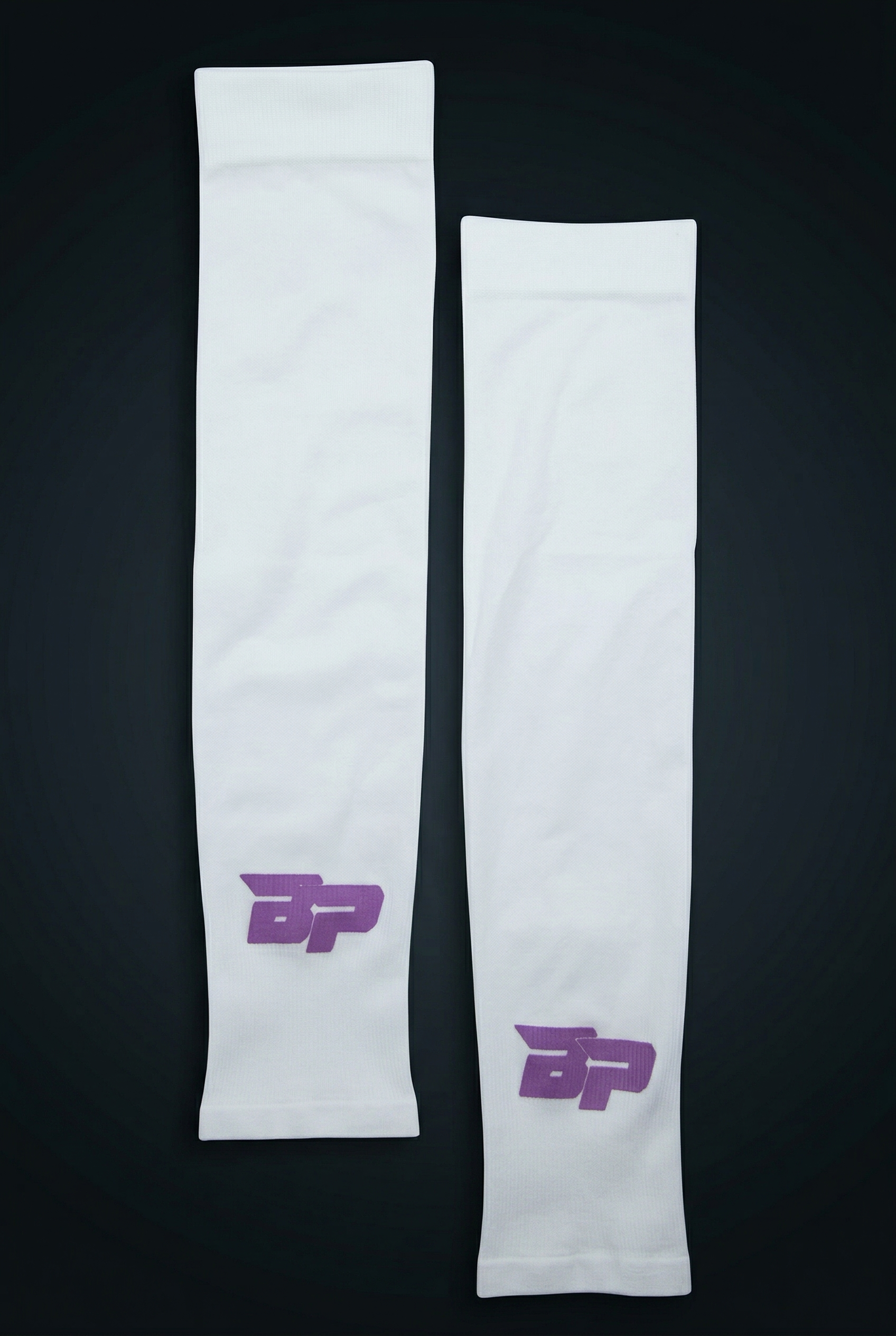 White Performance Arm Sleeves by Bodhi Pickleball, featuring purple BP logos and textured fabric, laid flat.