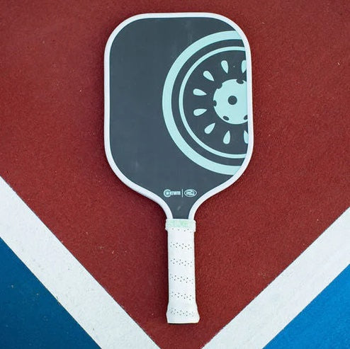 Pickleball paddle with a black and white design on a red and blue background