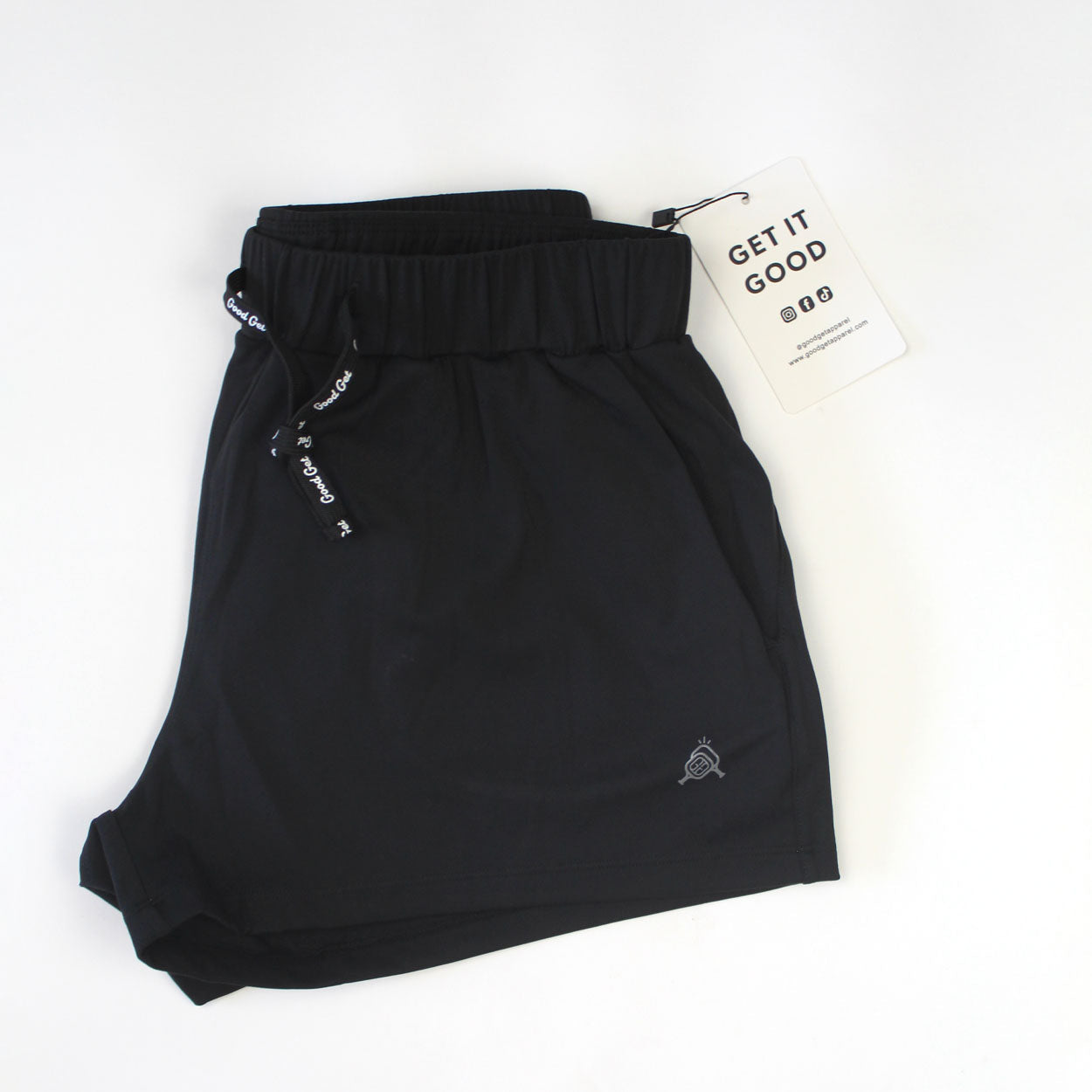Black shorts with drawstring and tag.