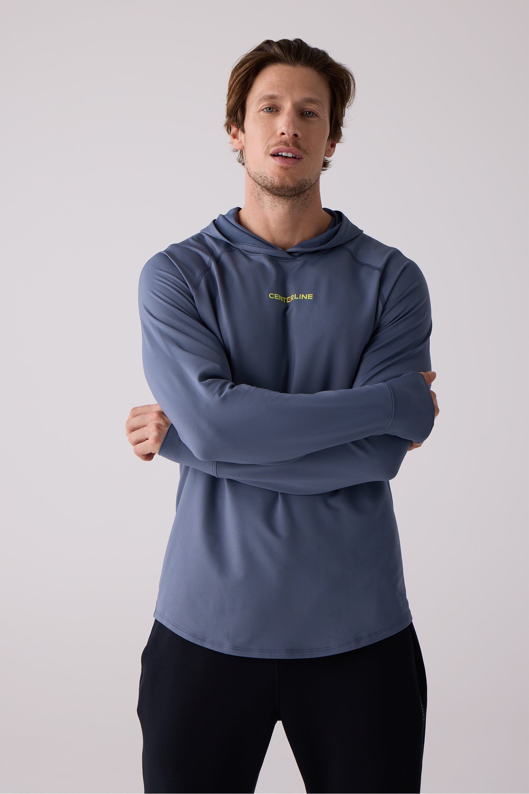 Dark blue men's layering hoodie by Centerline Athletics with yellow CENTERLINE chest logo, thumbholes, and visible stitching.