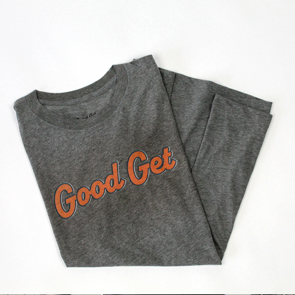 Grey T-shirt by Good Get, featuring "Good Get" script in orange, folded neatly.
