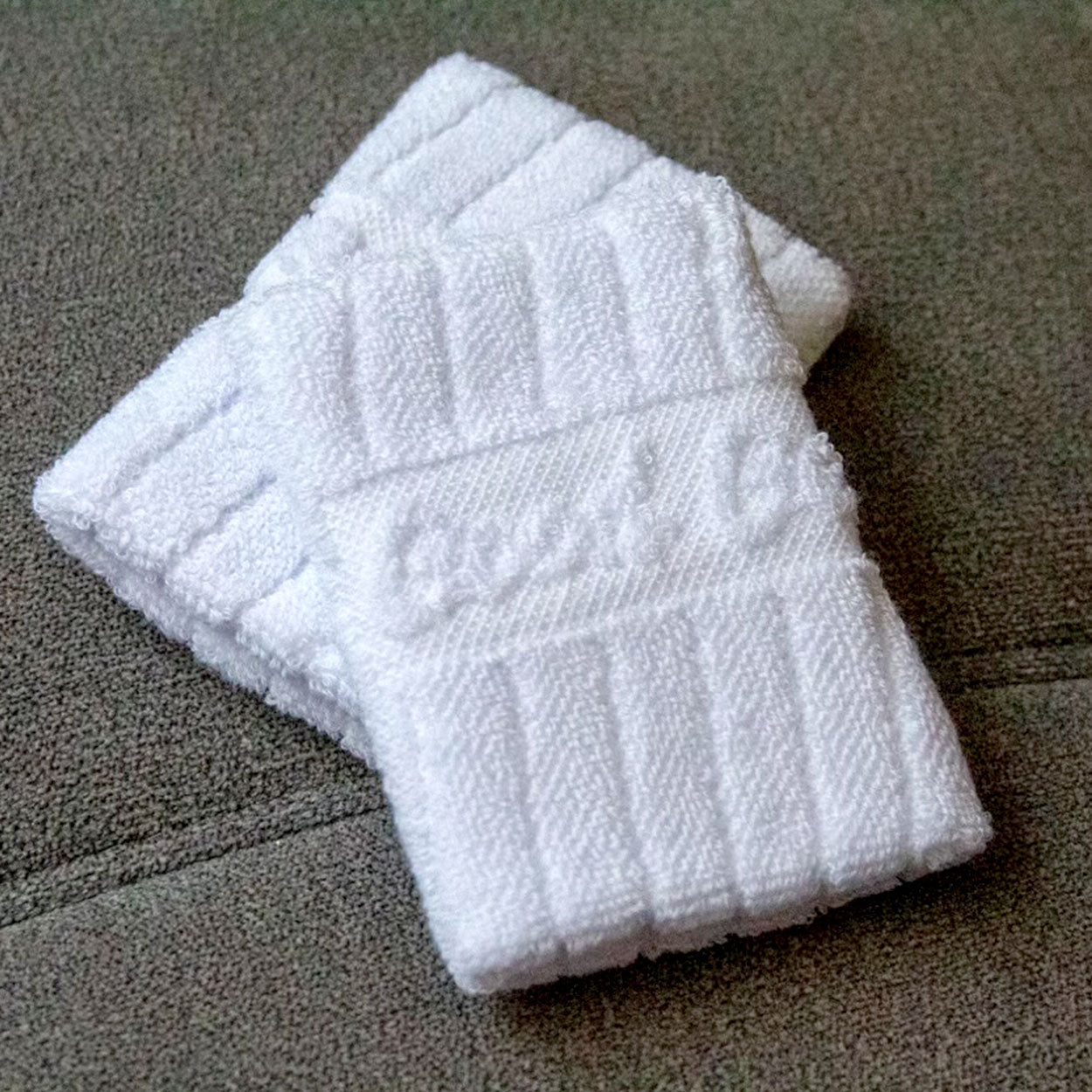 Two white folded washcloths.