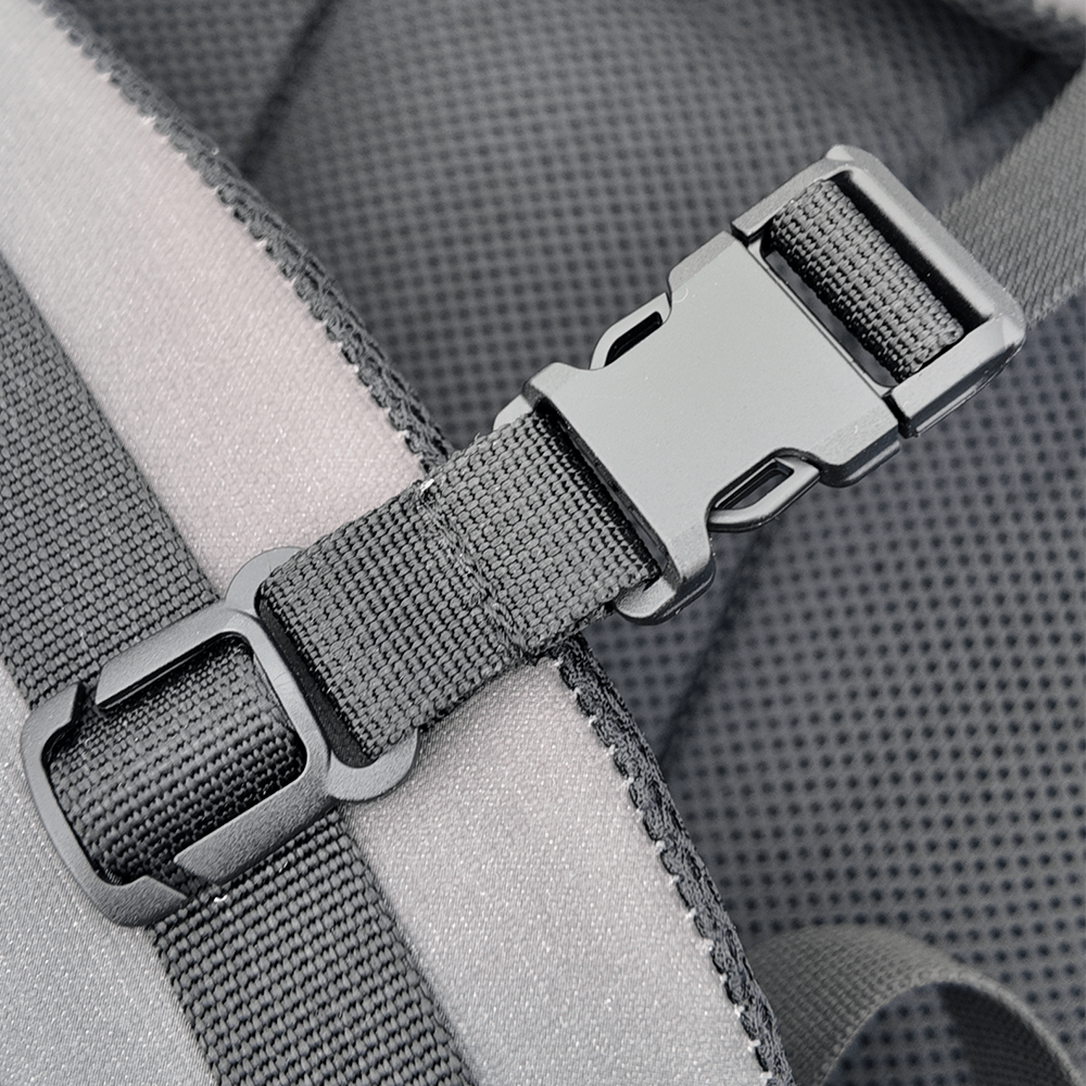 Close-up of a gray backpack's straps and buckles.