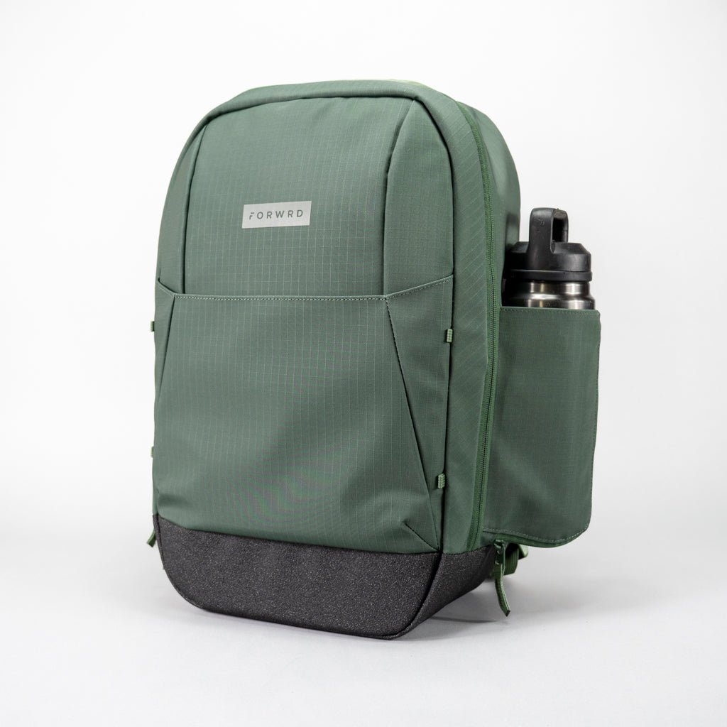 Green backpack with a water bottle in the side pocket.