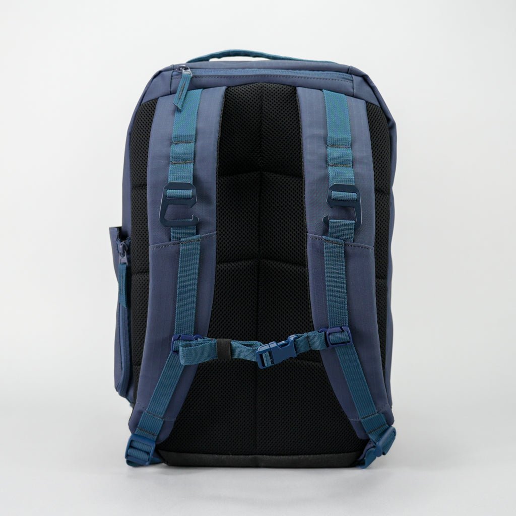 Blue backpack with dark straps and mesh back.