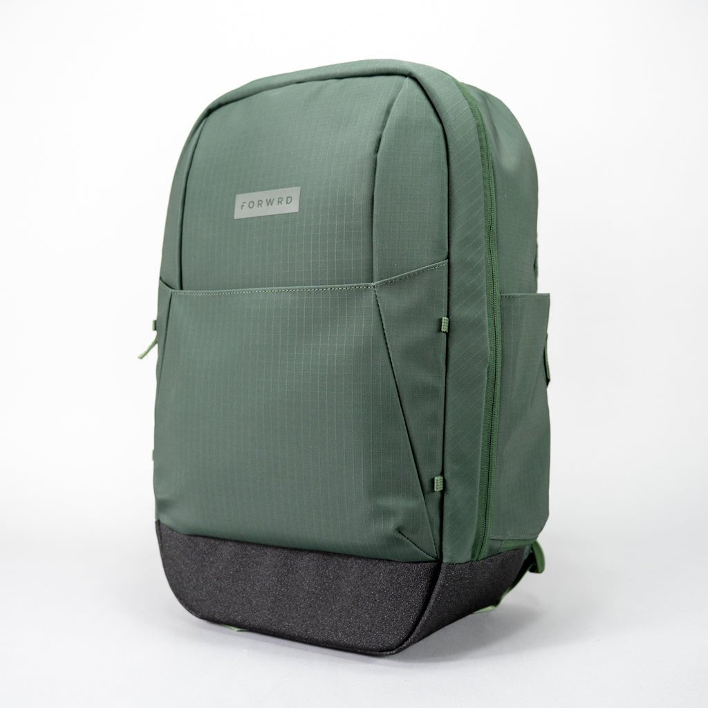 Olive green pickleball backpack by FORWRD, featuring a subtle ripstop grid pattern and a black textured base, in an angled front view.