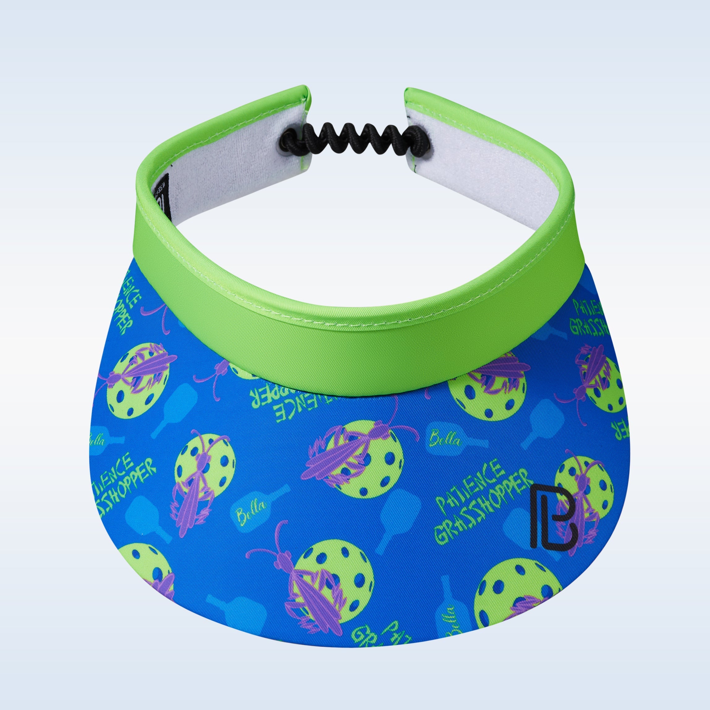 Green and blue visor by Pickleball Bella, with grasshopper and pickleball pattern, and an adjustable coiled cord.