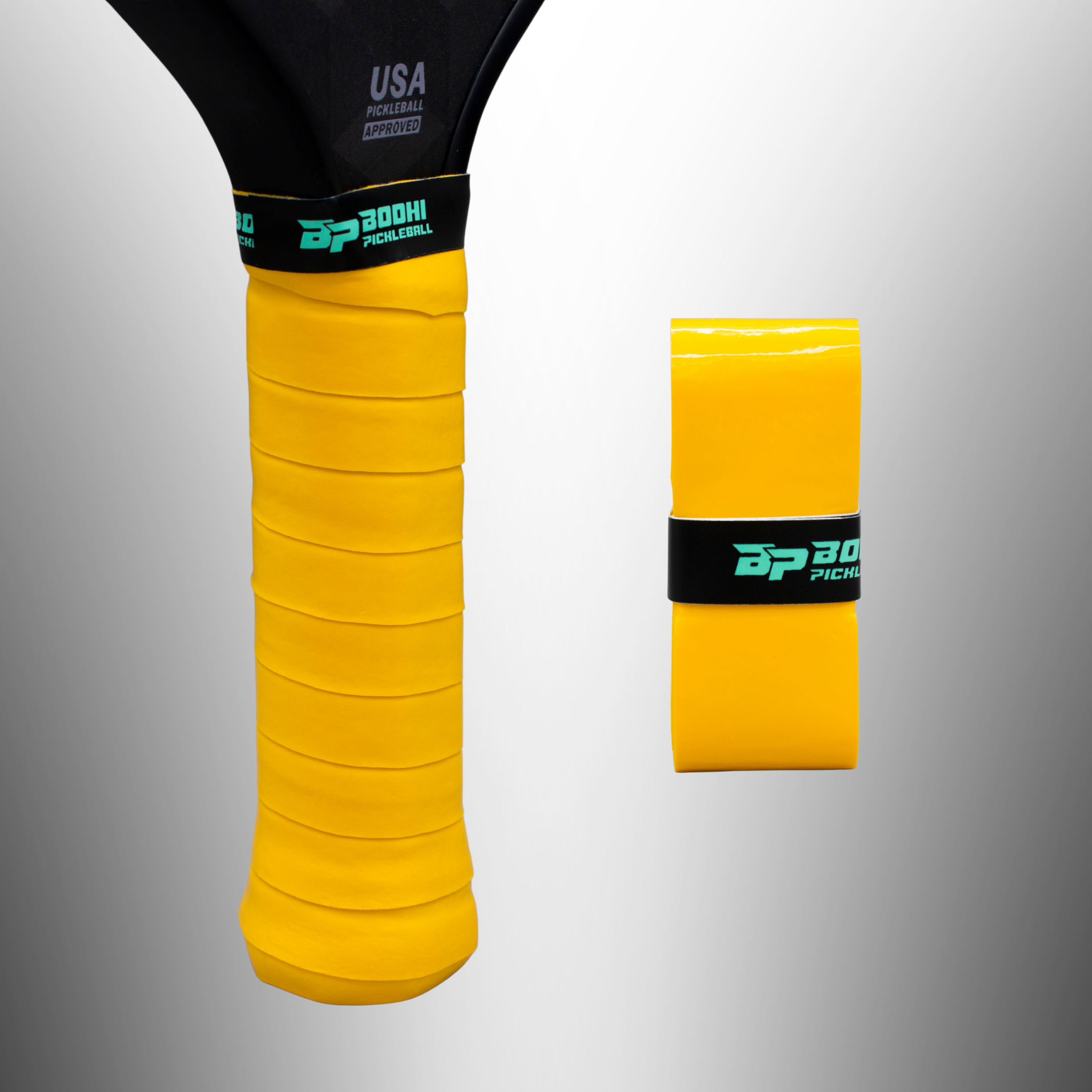 Yellow pickleball paddle overgrip by Bodhi Pickleball, one wrapped on a black paddle, one rolled, both with a teal logo band.