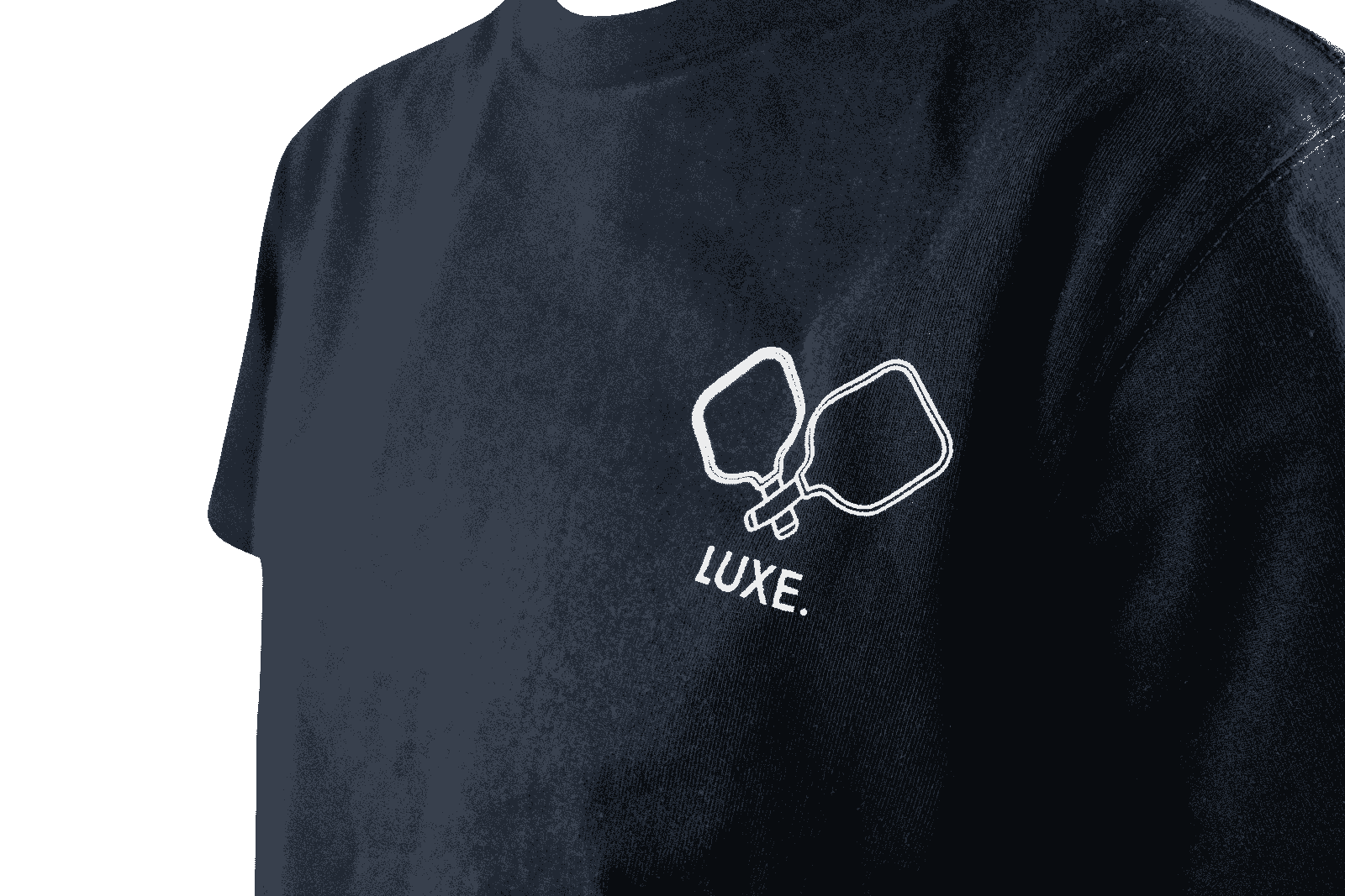 Close-up of a navy blue t-shirt featuring a white pickleball paddle design and the word "LUXE" underneath.
