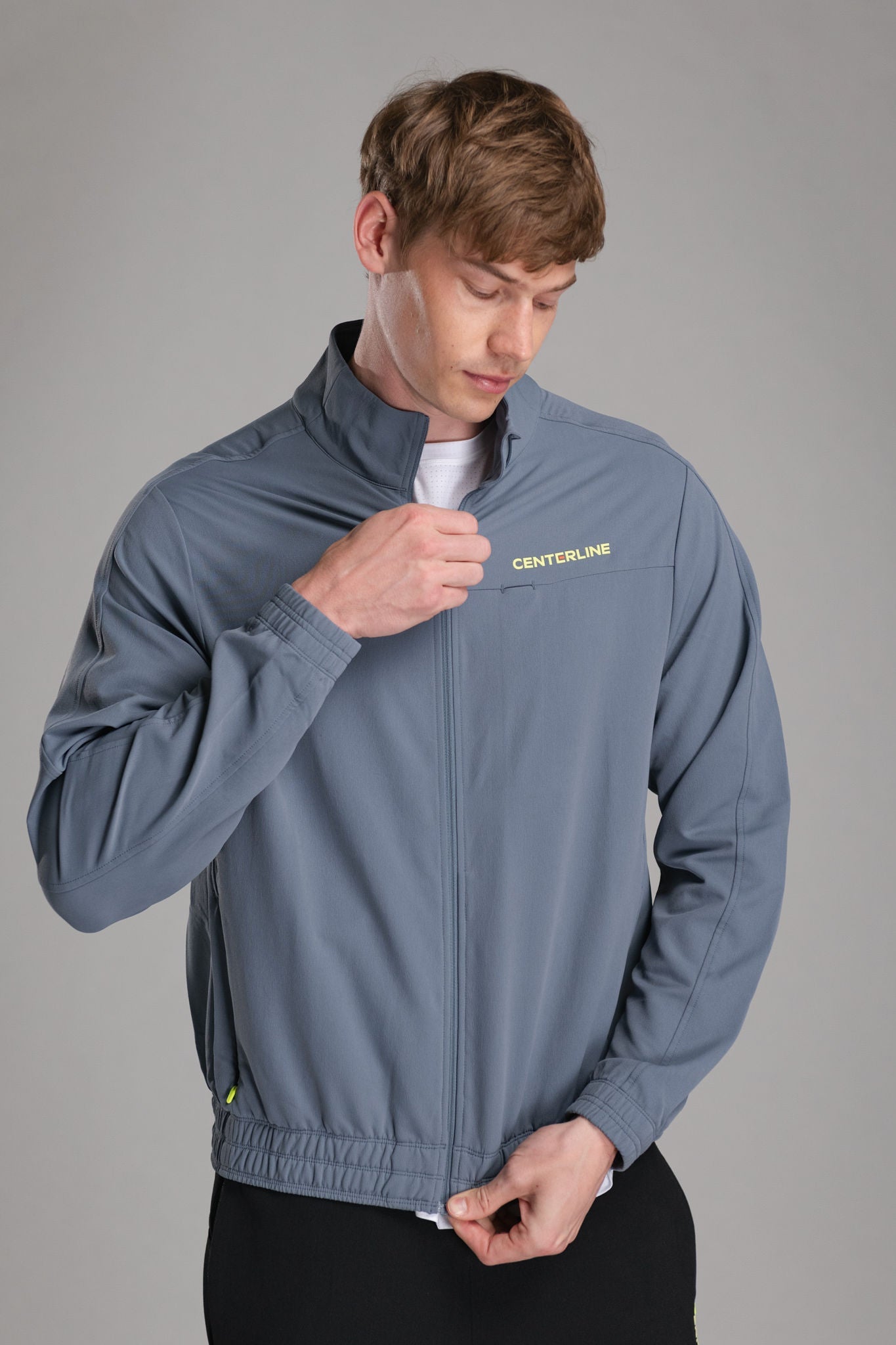 A man in a gray zip-up jacket.