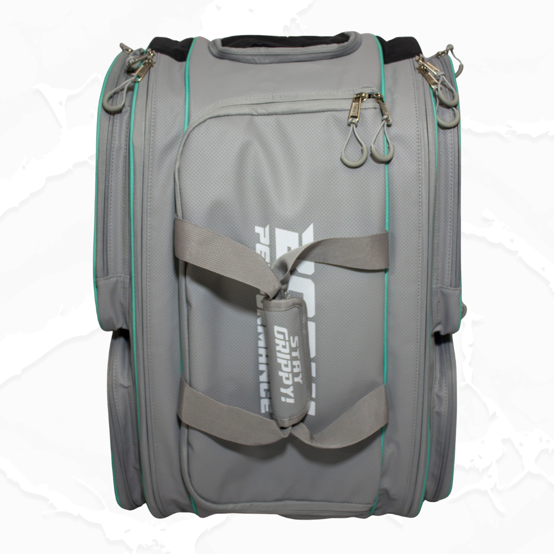 Grey fabric duffle bag by Bodhi Pickleball with turquoise trim, textured material, zippers, and "STAY GRIPPY!" text on straps.