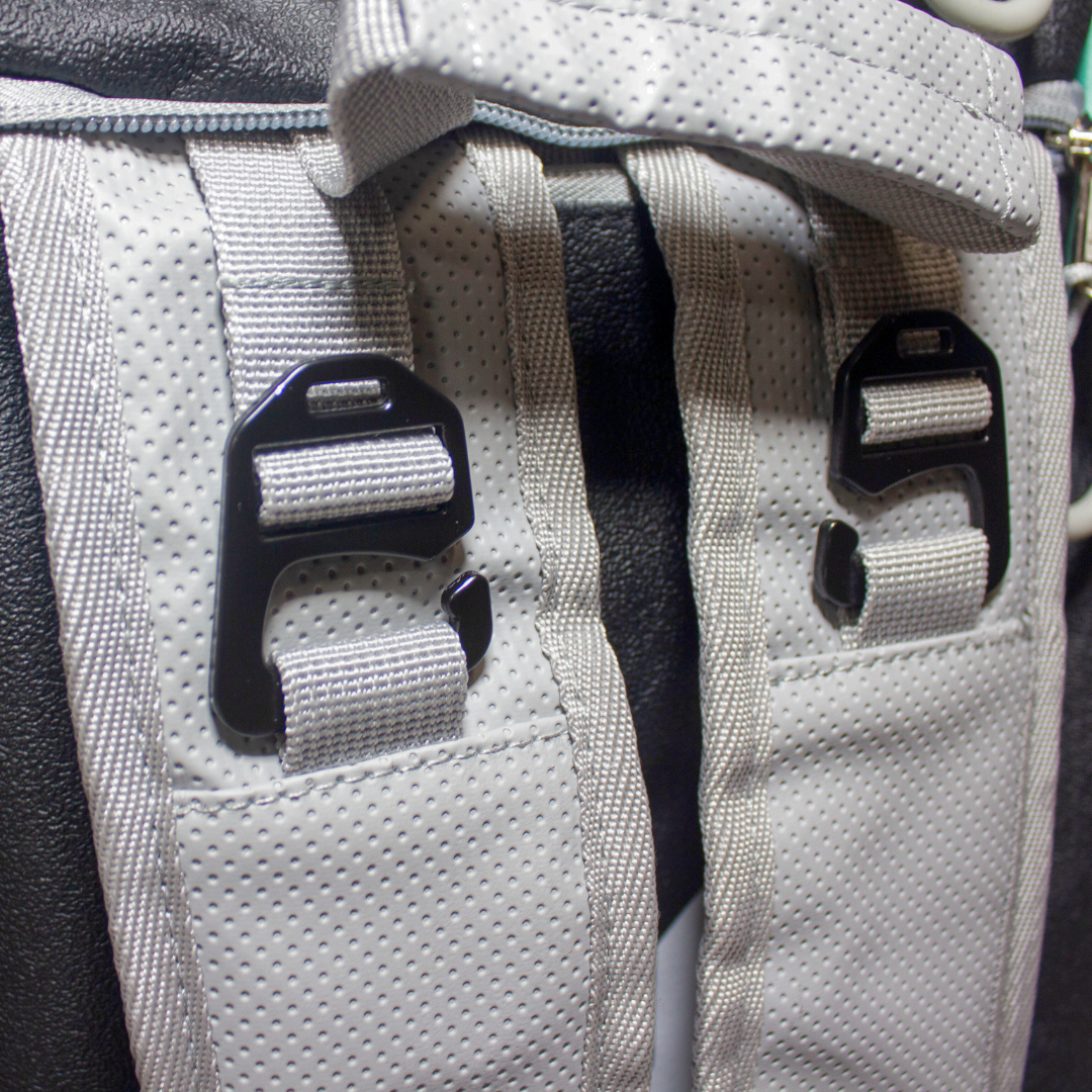 A grey PROtour Duffle by Bodhi Pickleball, featuring perforated fabric texture, black hooks, and webbing straps.