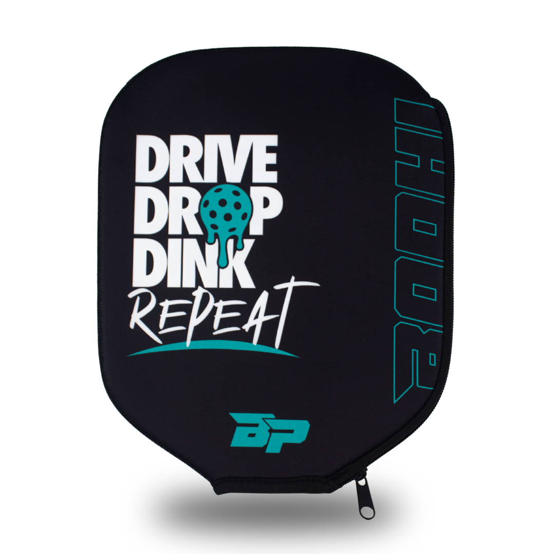 Black paddle cover by Bodhi Performance with white 'DRIVE DROP DINK REPEAT' text featuring a melting teal pickleball, vertical 'BODHI' outline, and a teal 'BP' logo.