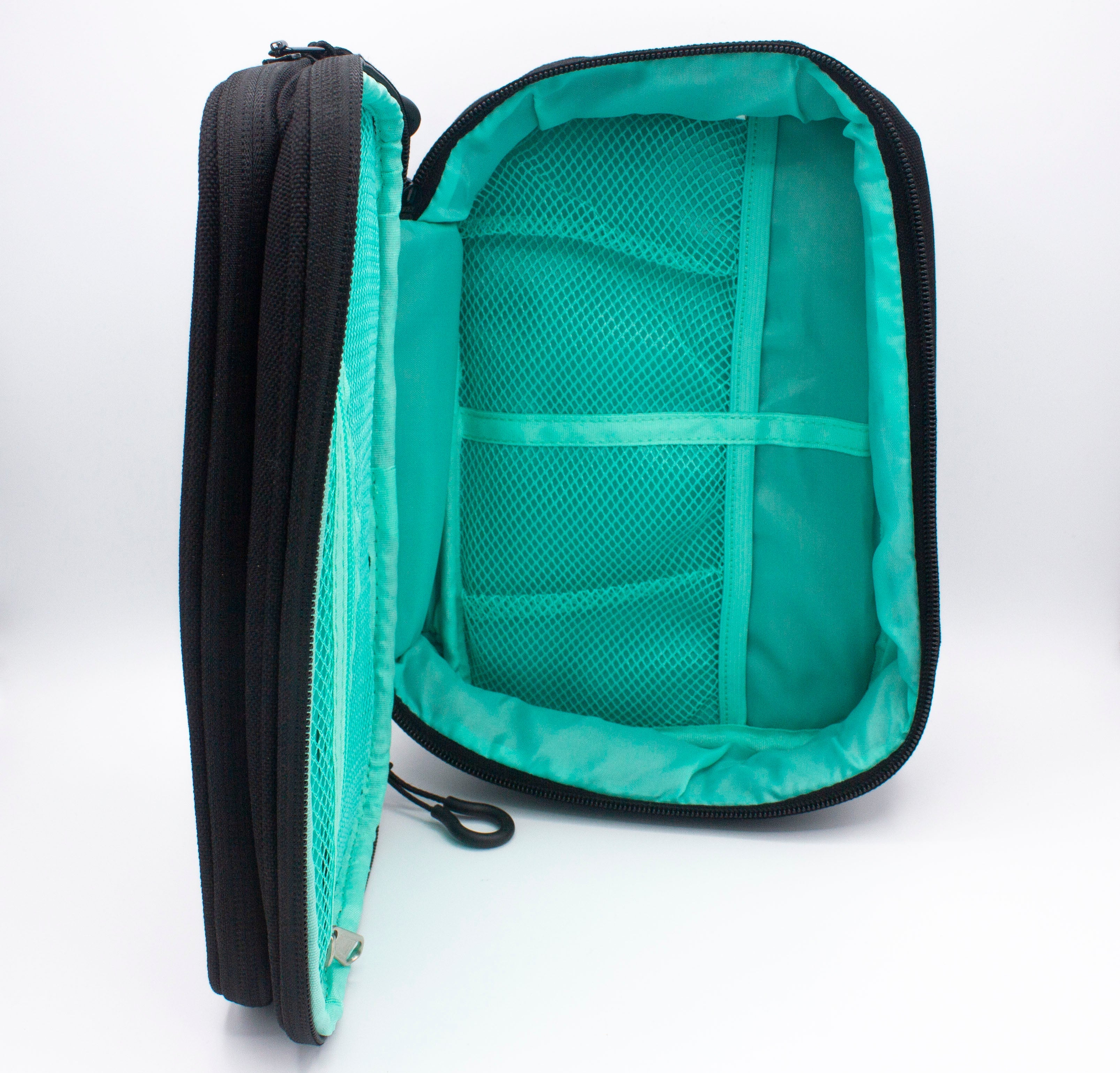 Black woven accessory case by Bodhi Performance, open to reveal a teal interior with mesh pockets and elastic straps.