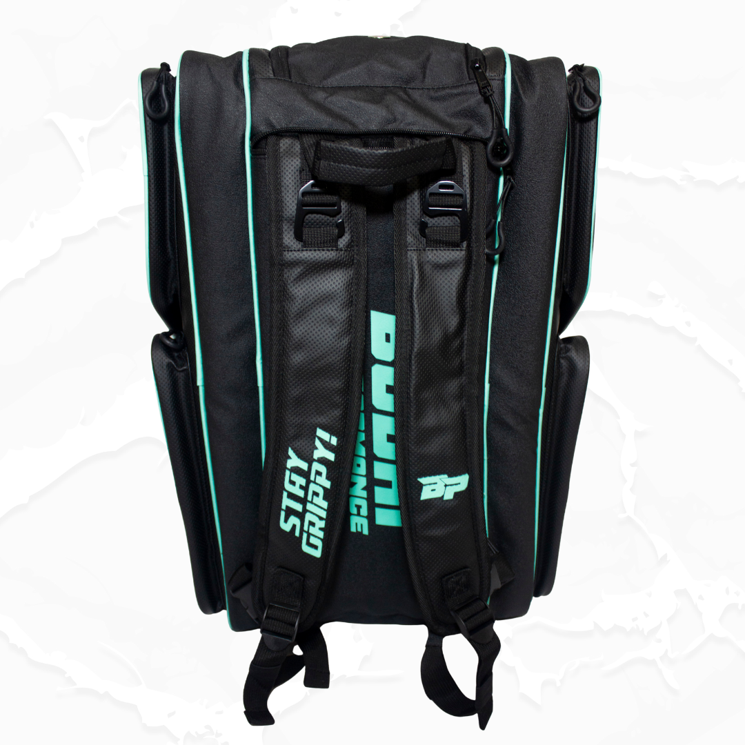 Black fabric duffle bag by Bodhi Pickleball, back view with perforated panel, teal piping, "DUCATI" and "STAY GRIPPY!" text, plus a BP logo.
