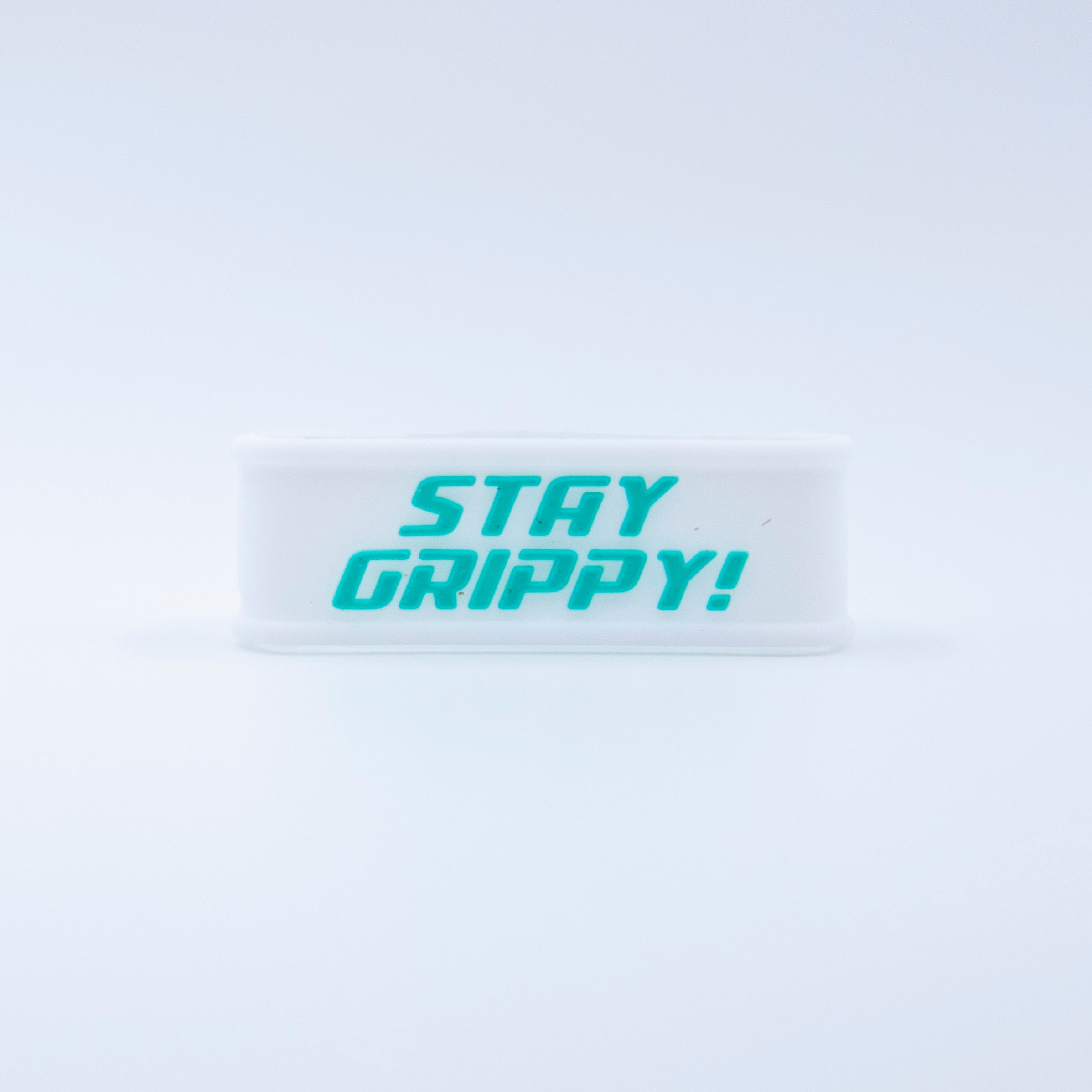 White wristband with teal text reading "STAY GRIPPY!"